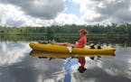 Courtney Lewis floated down the St. Croix River north of St. Croix Falls, Wis. The river current of about 3 mph made for easy paddling.