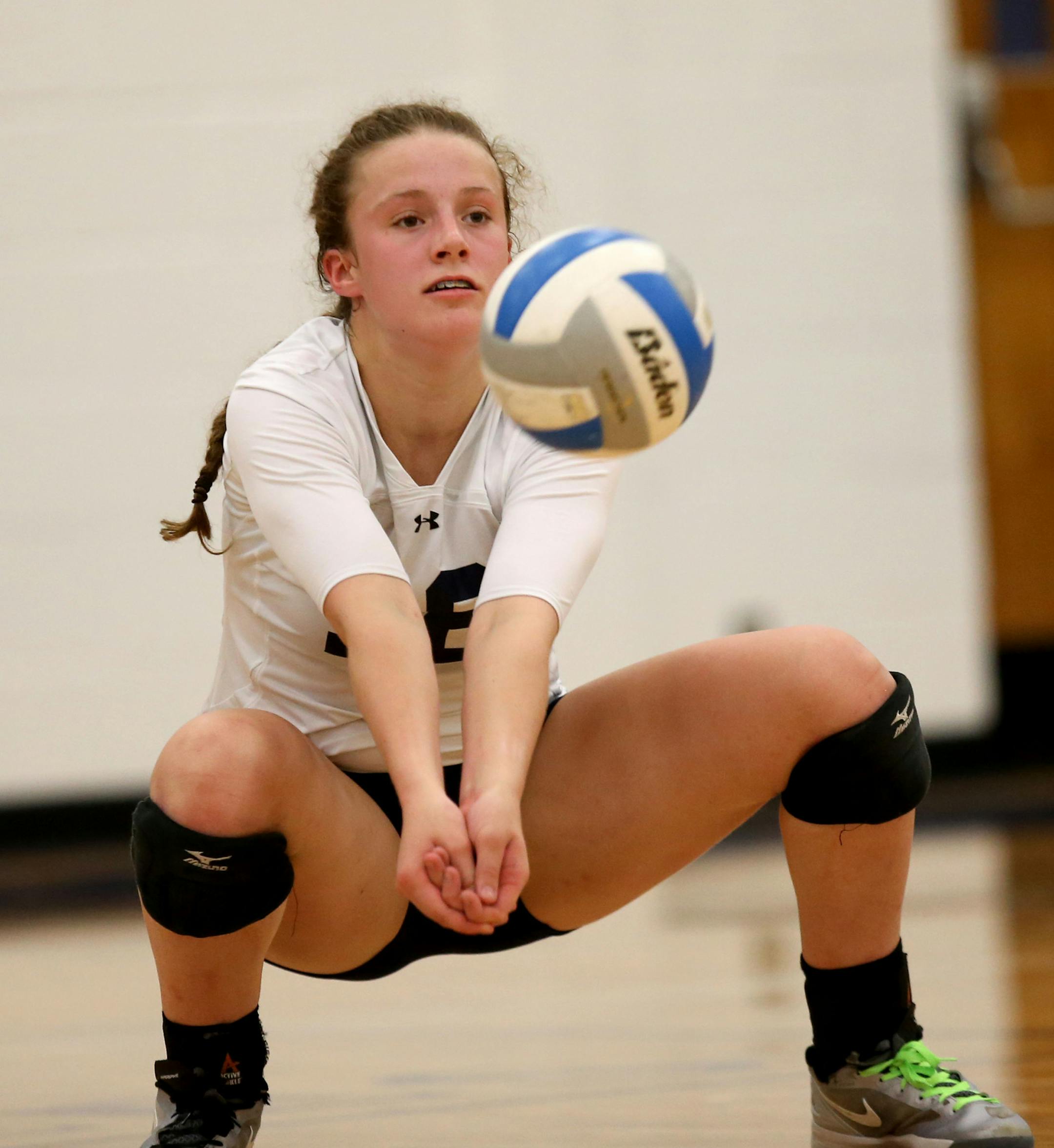 Totino-Grace's Madison Kroehler dug out a ball. ] (KYNDELL HARKNESS/STAR TRIBUNE) kyndell.harkness@startribune.com Volleyball Totino-Grace vs Spring Lake Park in Fridley Min., Thursday, August, 4, 2014.