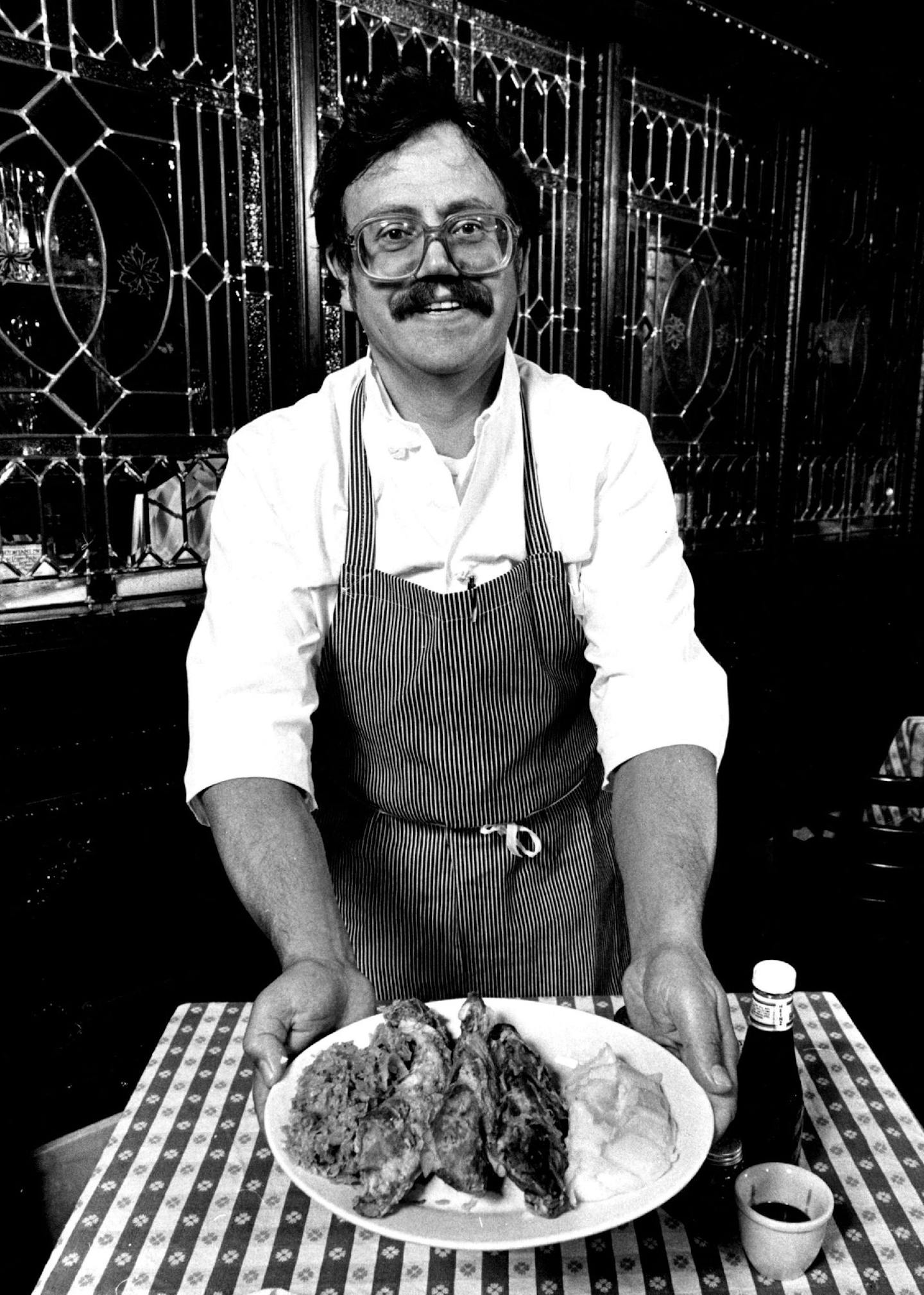 September 28, 1983 Sehr gut! Chef Erich Christ the Black Forest Inn displayed a traditional German meal of braised pork ribs, sauerkraut and potatoes. He will be demonstrating German specialties Thursday through Sunday at German Fest '83 at Met Center in Bloomington. The festival will celebrate the 300th anniversary of German immigration to the United States, with German dancing and bands, exhibits, and of course, German food and drink. Rollbraten, spanferkel, sauer-braten, schnitzel and other G