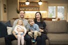 The Lampe family in their freshly finished basement: Dad Ryan with Olivia, 3, and Mom Kelly with Charlie, 5.