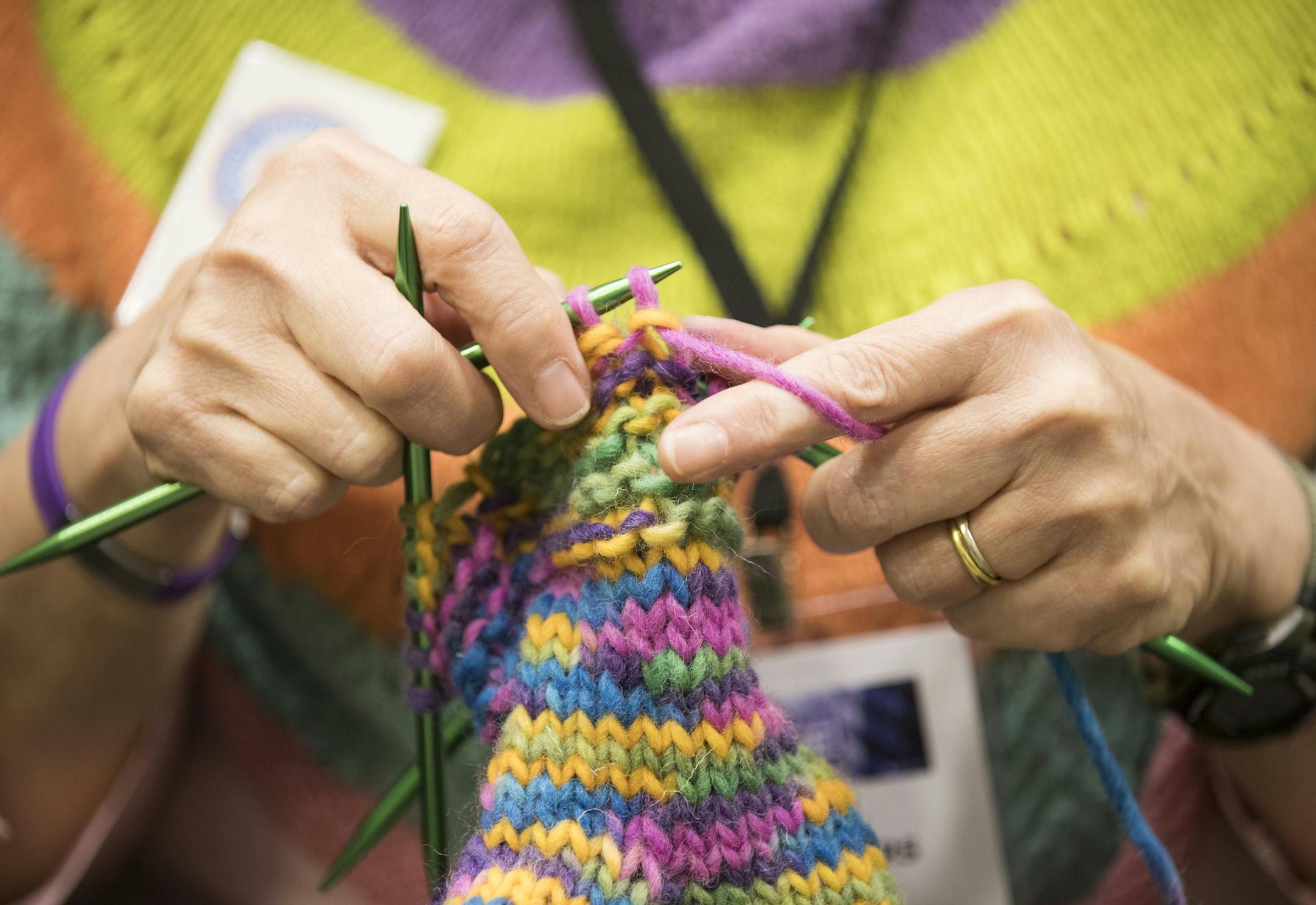 Kay Crowthers of the MN Knitter's Guild works on a pair of mittens during Vogue Knitting Live. ] (Leila Navidi/Star Tribune) leila.navidi@startribune.com BACKGROUND INFORMATION: The Vogue Knitting Live conference at the Minneapolis Convention Center on Sunday, November 6, 2016. The event features an opening yarn drop, boutique marketplace, workshops, a runway fashion show and yoga for knitters.
