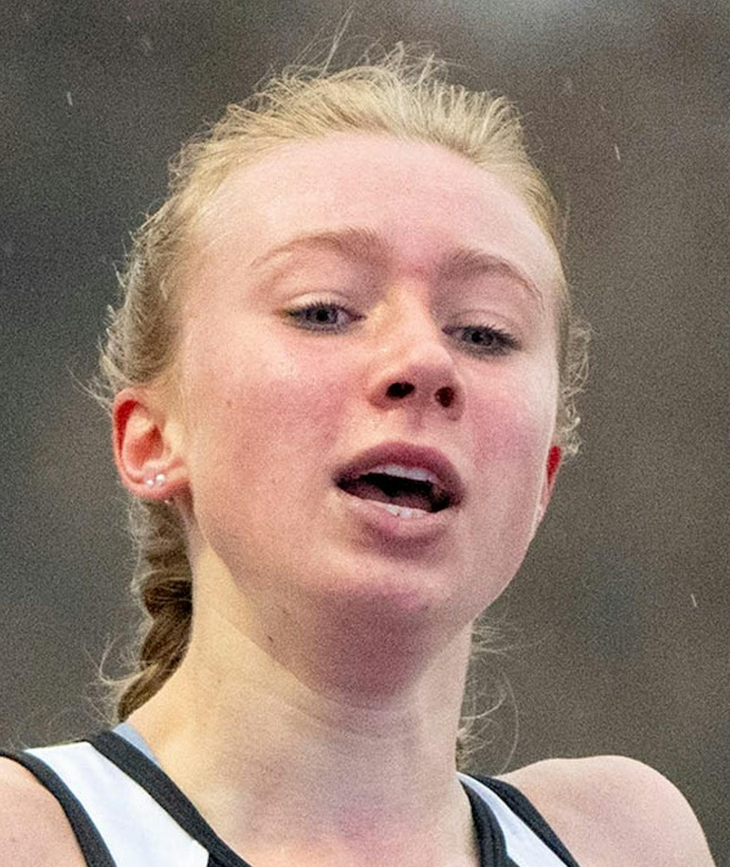 Hopkins distance runner Sydney Drevlow (3) crosses the finish line of the girl's 1600m race during the Hamline Elite Meet Friday, April 29, 2022 at Hamline University in St. Paul, Minn. ]