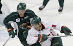 Minnesota Wild defenseman Ryan Suter, top left, and left wing Zach Parise, bottom right, take part in a scrimmage during NHL hockey training camp in S