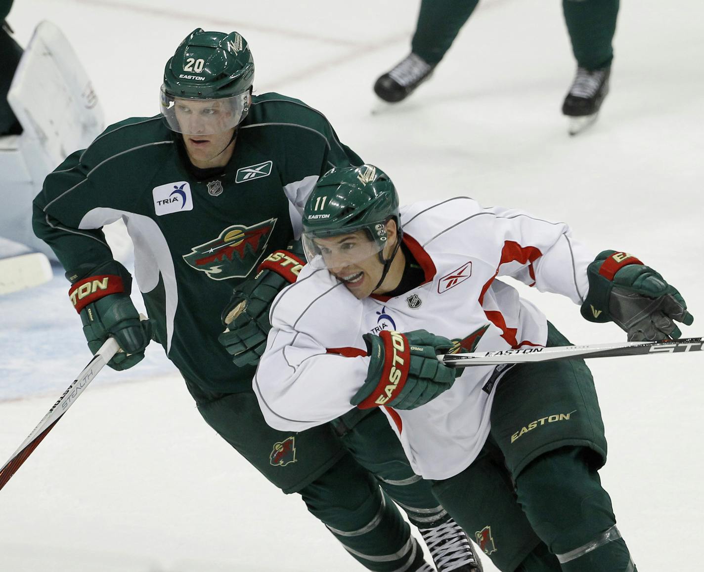 Minnesota Wild defenseman Ryan Suter, top left, and left wing Zach Parise, bottom right, take part in a scrimmage during NHL hockey training camp in St. Paul, Minn., Friday, Sept. 18, 2015. (AP Photo/Ann Heisenfelt)