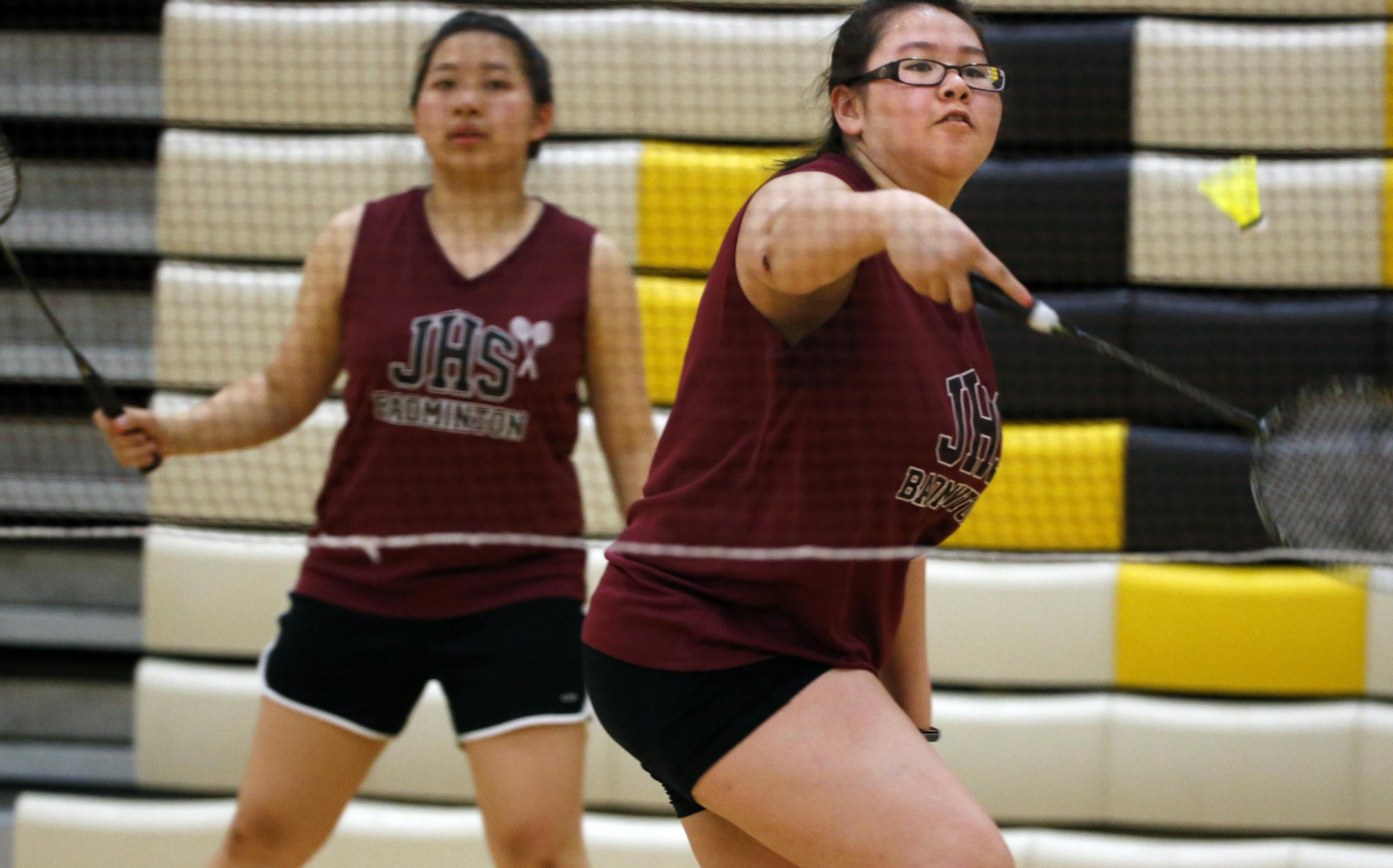 At the badminton tournament at Burnsville H.S., Kar Bao Xiong and Julie Her(right) of Johnson faced off against Washington players Moo Plut and Ku Meh in a doubles final. The Johnson duo won the match.] Richard Tsong-Taatarii/rtsong-taatarii@startribune.com
