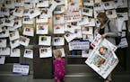 Supporters of "Medicare for All" display photos of people who have relied on crowdfunding to pay for their medical expenses, in Washington, April 29, 