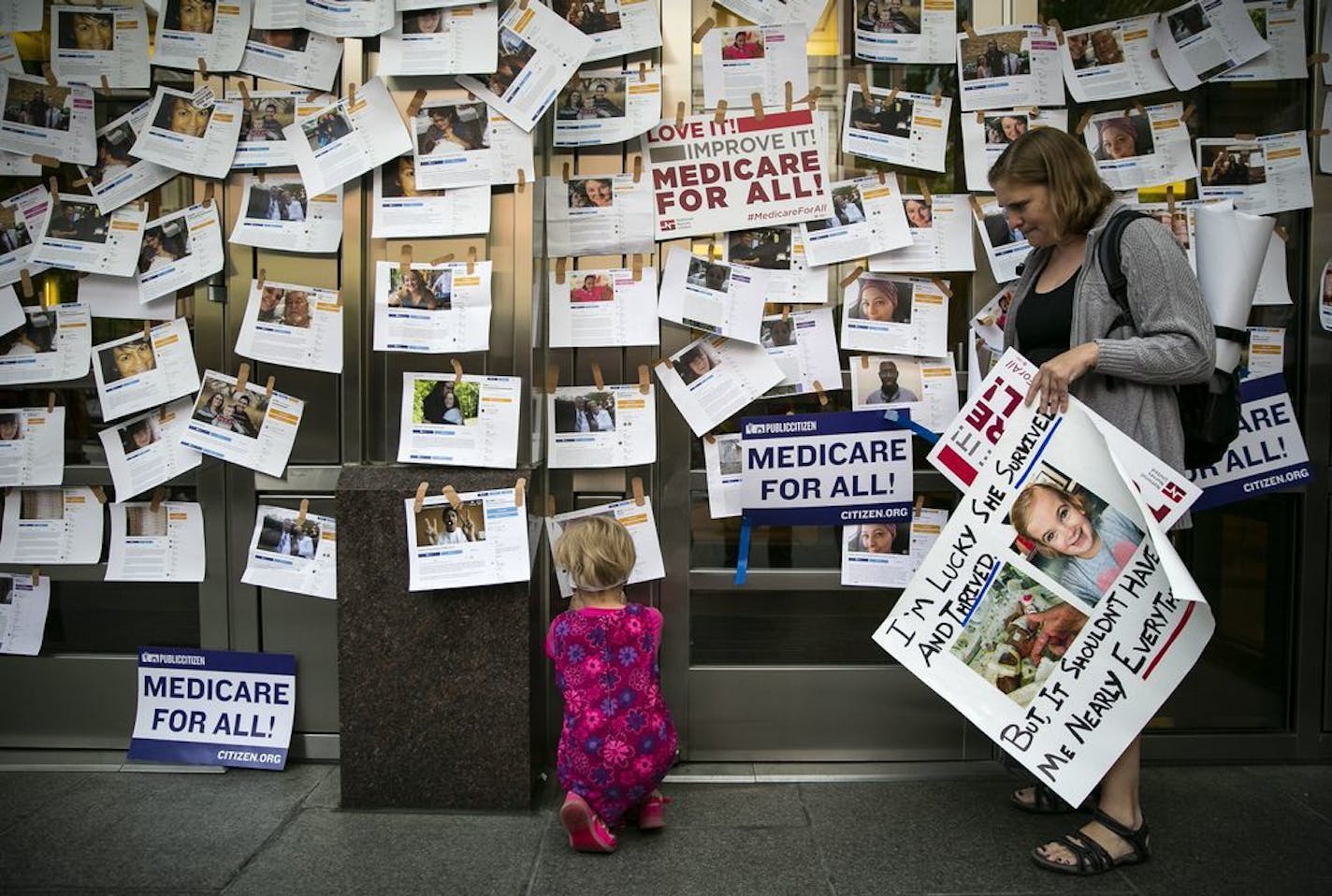 Supporters of "Medicare for All" display photos of people who have relied on crowdfunding to pay for their medical expenses, in Washington, April 29, 2019.