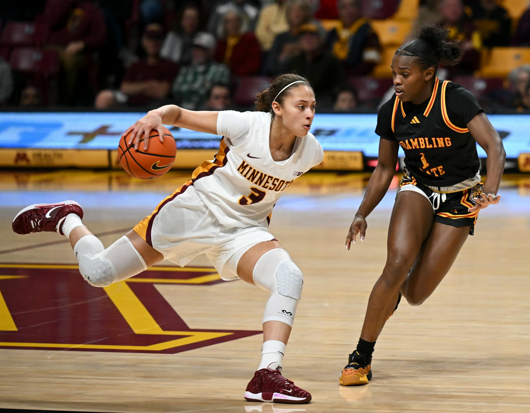 Minnesota Gophers guard Amaya Battle (3) controls the ball against Grambling Lady Tigers guard Douthshine Prien (1) in the first half.