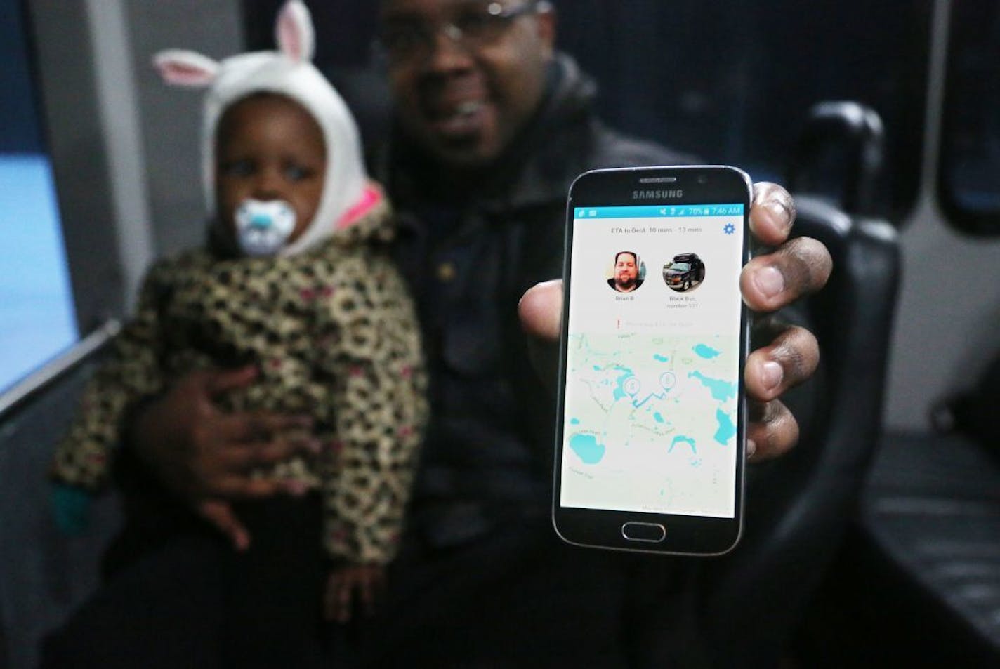 Josh Phillips and his daughter Laree, 1, take the Prime service from SouthWest Transit bus to Laree's daycareTuesday, Jan. 10, 2016, in Eden Prairie, MN. Here, Phillips show his app for the service on his phone.