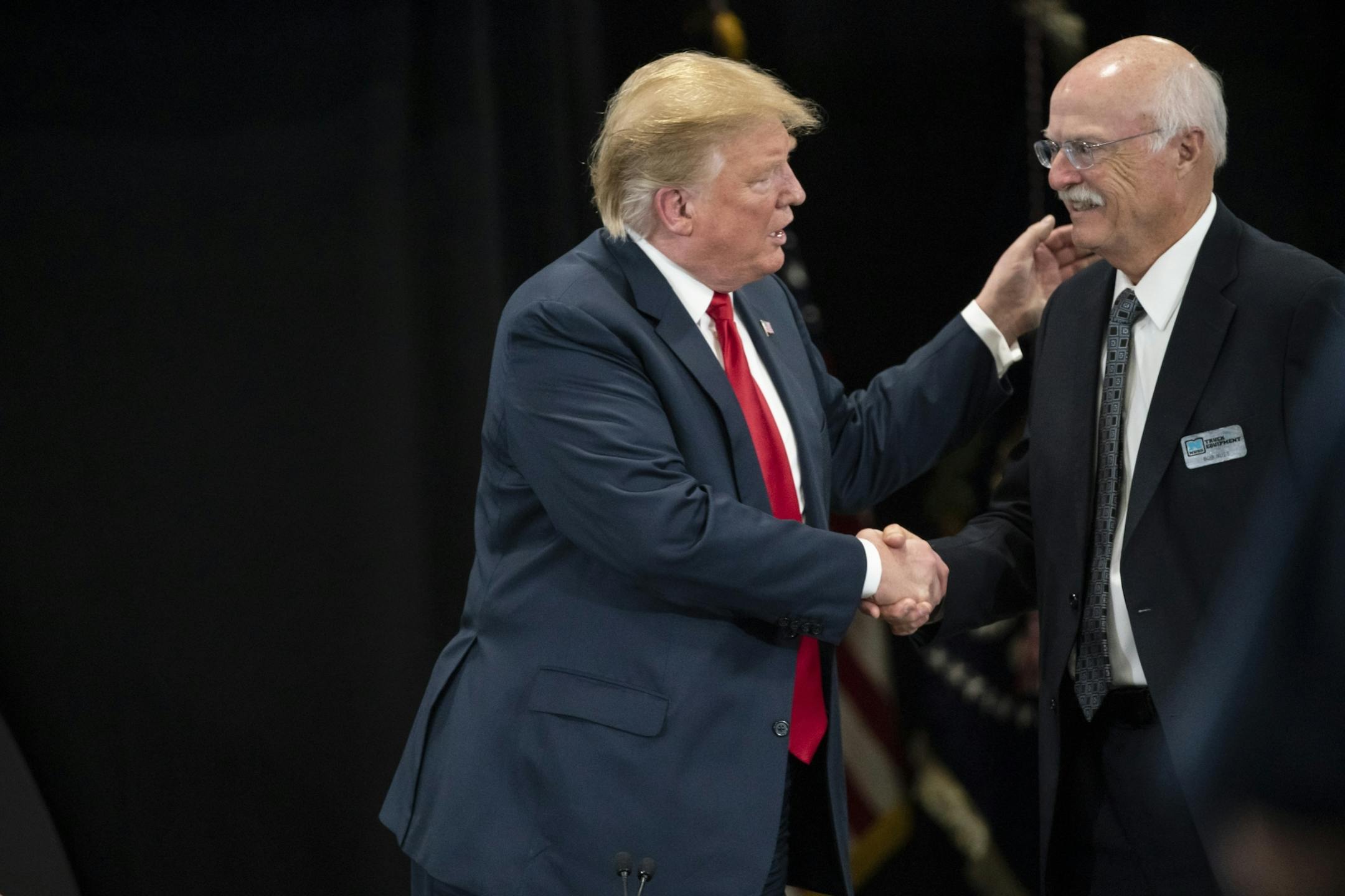 President Donald J. Trump shook shook hands with Nuss Truck and Equipment president Bob Nash in Burnsville after a roundtable discussion on tax cuts and the U.S. economy in Burnsville, Minn., on Monday, April 15, 2019.