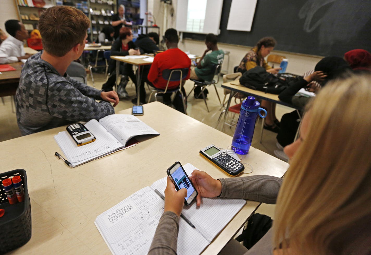 Kaida Bisbis (right) and Ben Murray (left) use their phones in Sara Van Der Werf's Advanced Algebra class at South High School in Minneapolis. ] An app called Desmos is a free graphing calculator that can be downloaded onto a phone for use in the classroom, and at home. At places like South High, it's a story of equity and access. Not all kids in the district can afford to shell out more than $100 for a graphing calculator, but most have phones or have a family member with one. Educators say it