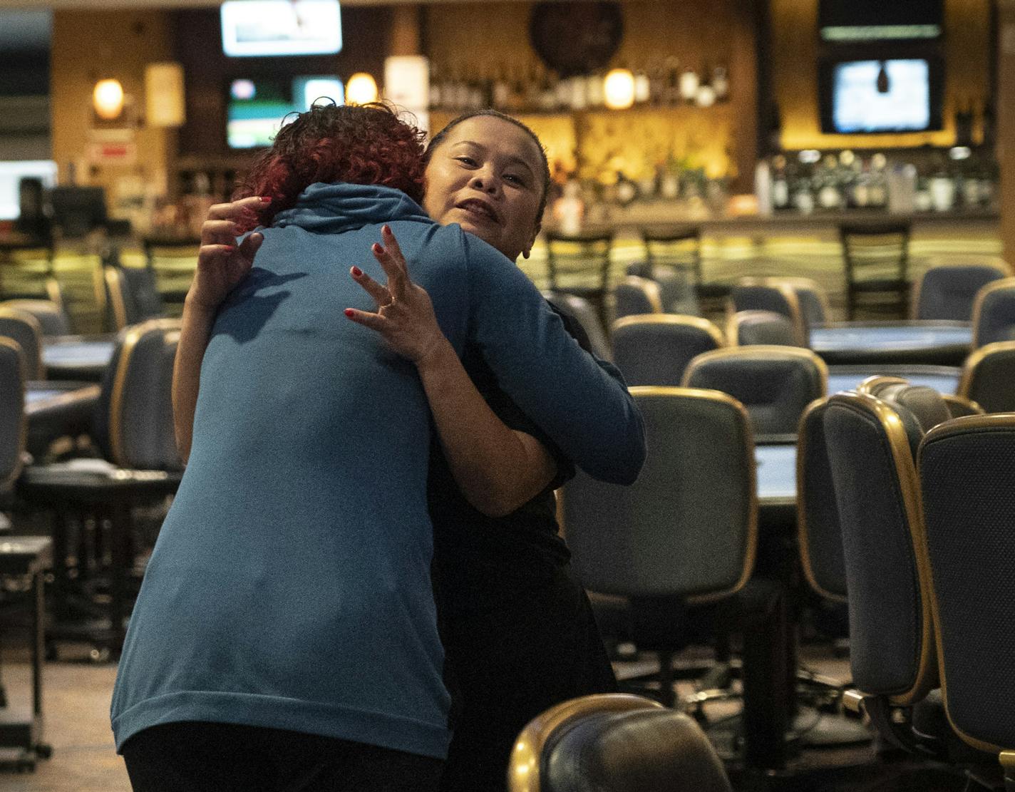 Server Julie Hvidsten hugged casino executive host Azure Alder (in blue) to say goodbye as they prepared to close Canterbury Park in Shakopee, Minn., on Monday, March 16, 2020 in response to concerns about COVID-19. Canterbury Park is traditionally open 24/7 only closing annually for 12 hours over Christmas. ] RENEE JONES SCHNEIDER &#xa5; renee.jones@startribune.com