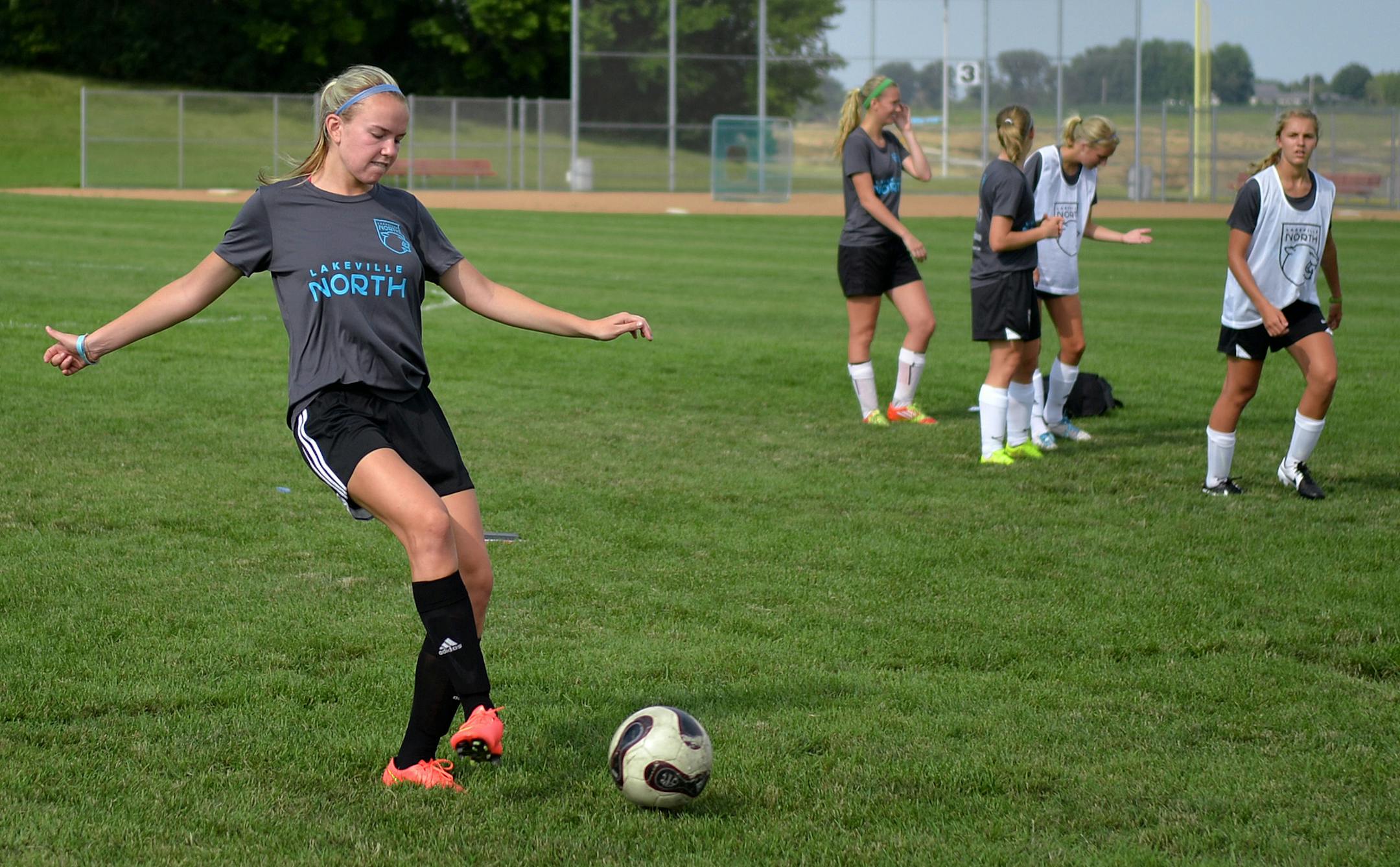 Lakeville North girls' soccer captain, Lindsay Frietag, and her teammates practice in t-shirts with light blue writing to honor former teammate, Alyssa Ettl, who was killed in a car accident last winter. ] (SPECIAL TO THE STAR TRIBUNE/BRE McGEE) **Alyssa Ettl (former Lakeville North High School girls' soccer player, not pictured), Lindsay Frietag (Lakeville North girls' soccer captain)