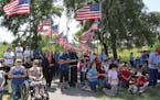 Catholic protesters gather at Veterans Memorial Park in Belle Plaine to protest inclusion of satanic symbol statute, part of a free-speech philosophic