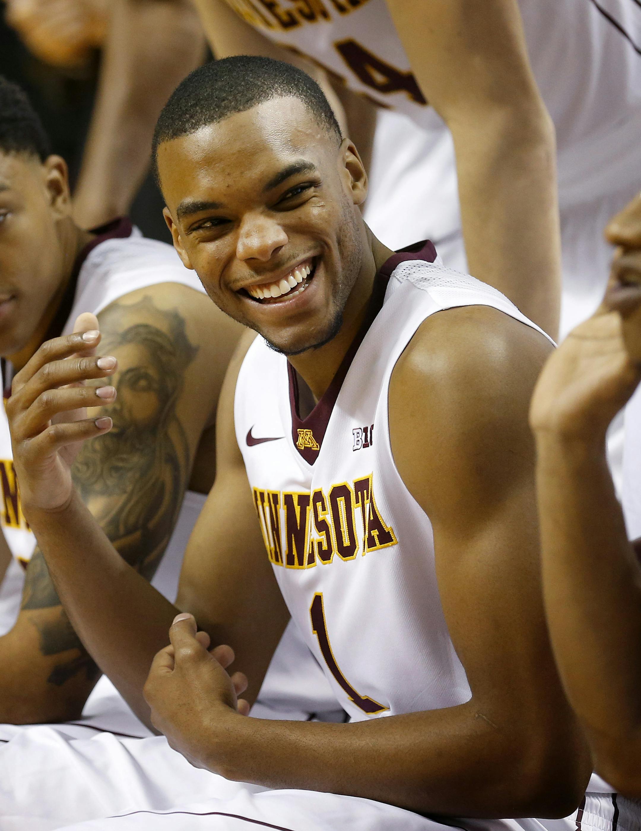 University of Minnesota senior Andre Hollins (1) joked with teammates before taking a team photo on Gophers media day. ] CARLOS GONZALEZ cgonzalez@startribune.com - October 21, 2014 , Minneapolis, MN, Williams Arena, University of Minnesota Men‚Äôs Basketball, Gophers, Gophers basketball media