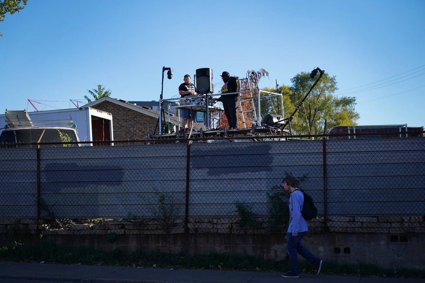 DJ Hayes (left) and Nur-D performed during a sound check on the roof stage of the van as a passerby walked by on the sidewalk below.