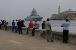People watch the Russian Navy Admiral Gorshkov frigate arrive at the port of Havana, Cuba, Wednesday, June 12, 2024.