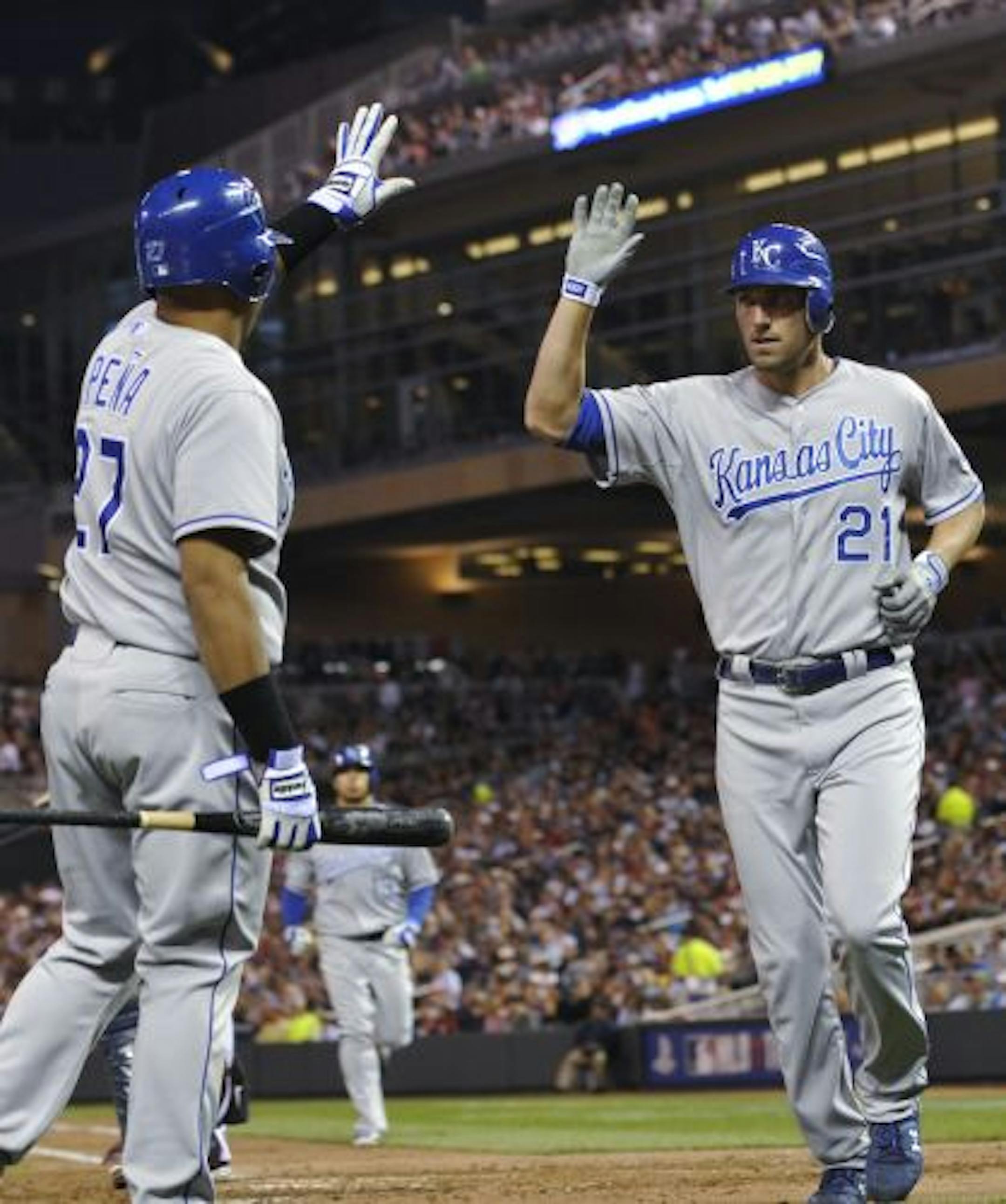 The Royals' Brayan Pena (left) greeted Jeff Francoeur after he scored on a sacrifice fly by Mike Aviles in the fourth inning against the Twins on Tuesday night.