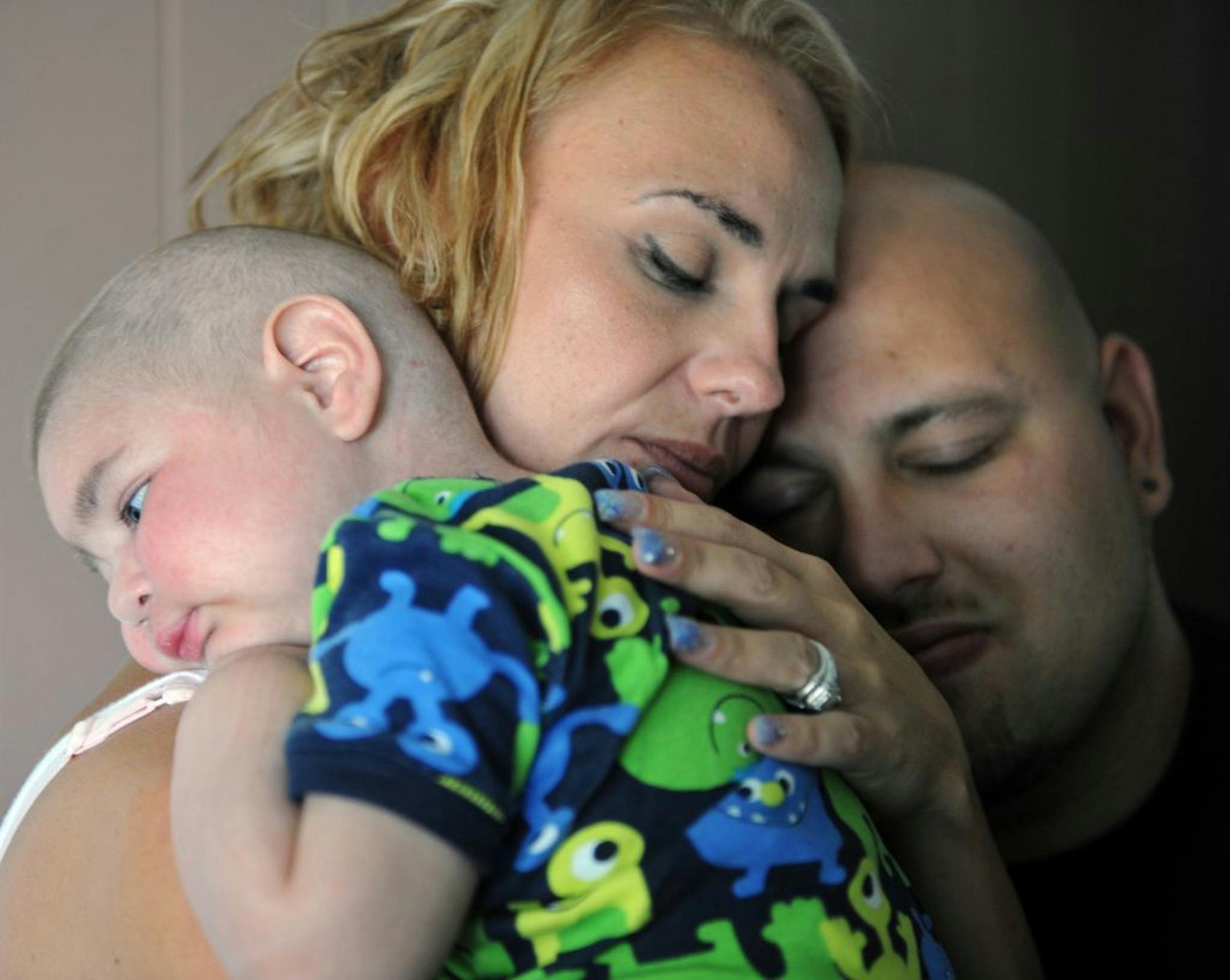 Christine Swidorsky holds her son, Logan Stevenson, 2, with her husband-to-be and Logan's father Sean Stevenson, for a portrait on Tuesday, July 30, 2013 in their Jeannette, Pa., home. The Pennsylvania couple plans to have their dying toddler serve as the groom's best man when they wed on Saturday, Aug. 3. The couple had planned to wed next year, but decided to move the ceremony up to Saturday so the boy, who has leukemia and other complications, could participate. Logan has Fanconi anemia, a ra