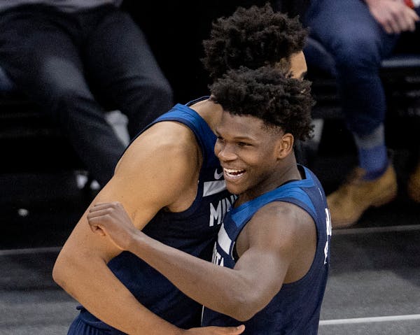 Karl-Anthony Towns (32) and Anthony Edwards (1) of the Minnesota Timberwolves celebrated at the end of the game.