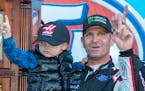 Clint Bowyer, right, and his 3-year-old son, Cash, celebrated after winning a NASCAR race at Martinsville Speedway in Martinsville, Va., on Monday.
