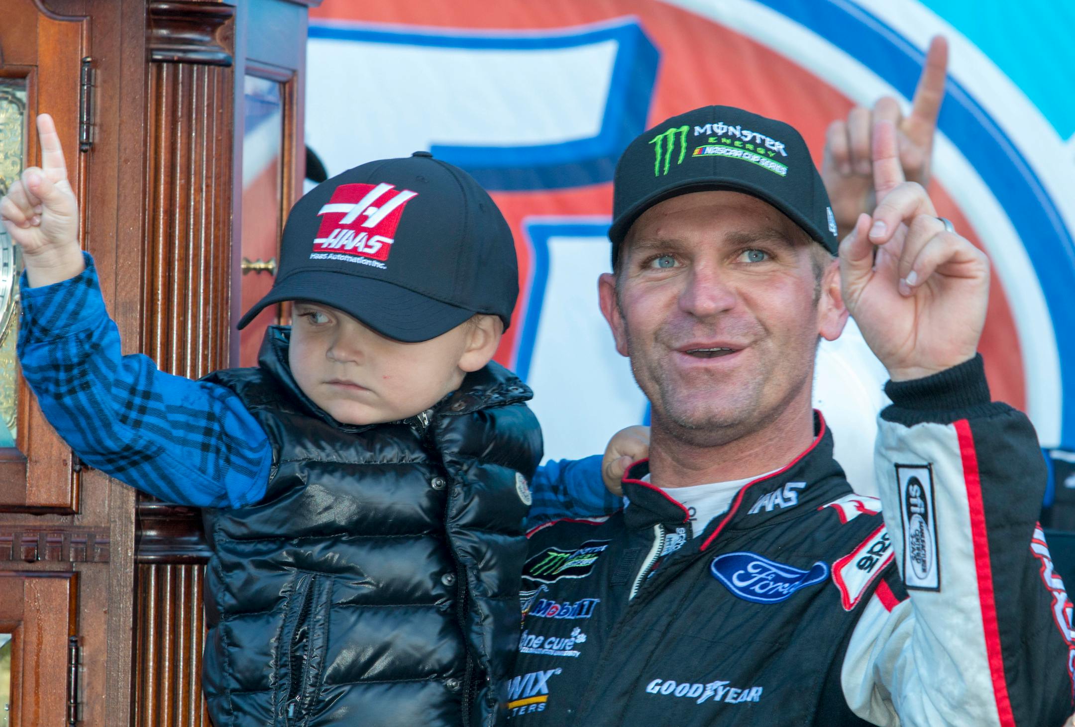 Clint Bowyer, right, and his 3-year-old son, Cash, celebrated after winning a NASCAR race at Martinsville Speedway in Martinsville, Va., on Monday.