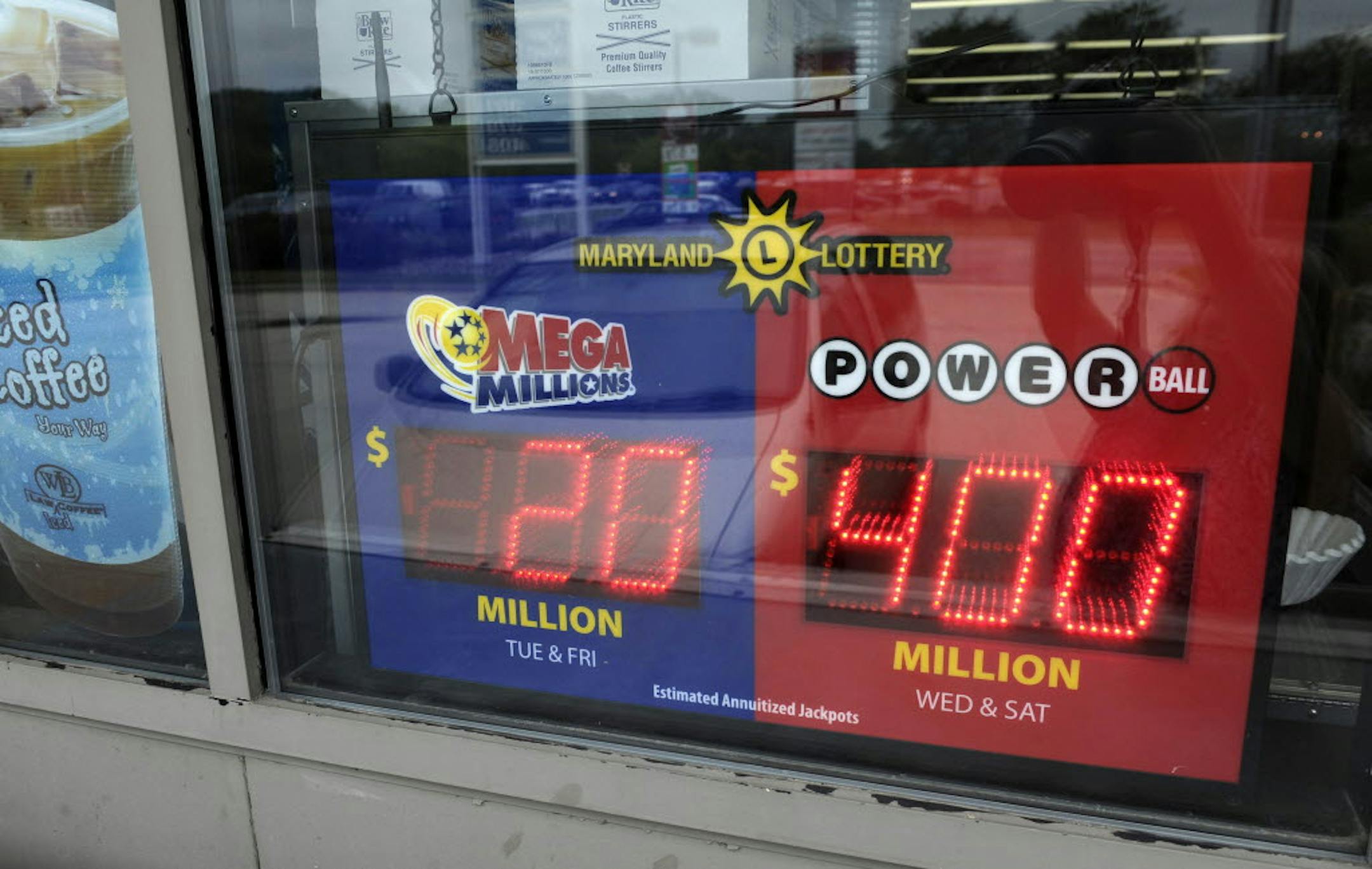 A sign showing the estimated winnings of the Powerball jackpot hangs in the window of a gas station in Bowie, Md., Tuesday. The jackpot grew to an estimated $448 million.