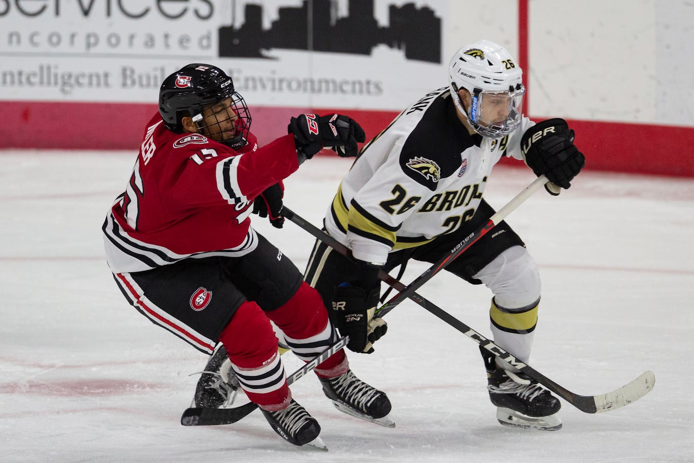 St. Cloud State forward Micah Miller (15) gets tangled up with Western Michigan forward Ethen Frank's (26) stick during an NCAA hockey game on Tuesday, Dec. 1, 2020, in Omaha, Neb. (AP Photo/John Peterson)