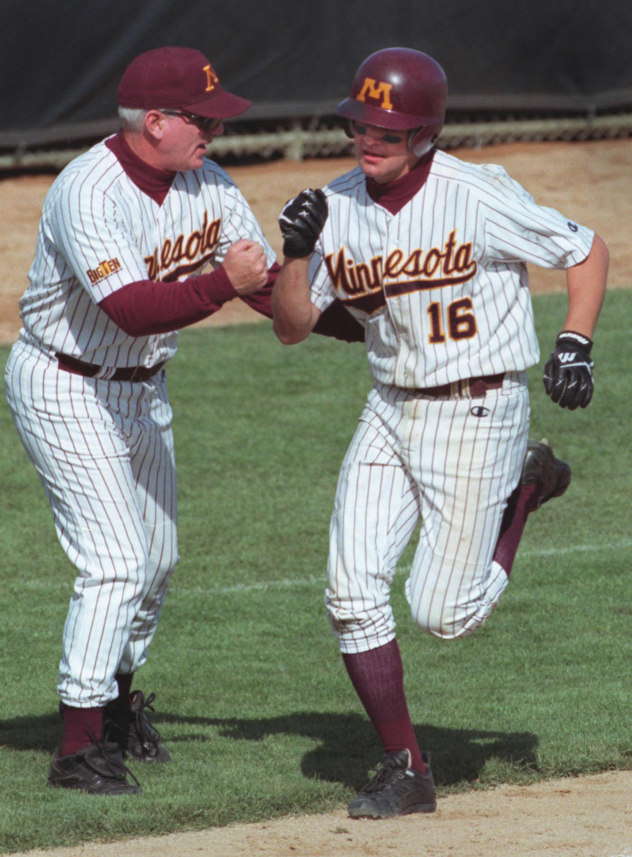 Minneapolis, MN., Thursday, 5/18/2000. (left to right) Third base coach Rob Fornasiere celebrated with Gophers #16 Luke Appert as he headed home after hitting his second home run of the game in the 5th inning. First game of Big Ten tournament. Action photos of Gophers baseball vs. Northwestern University.