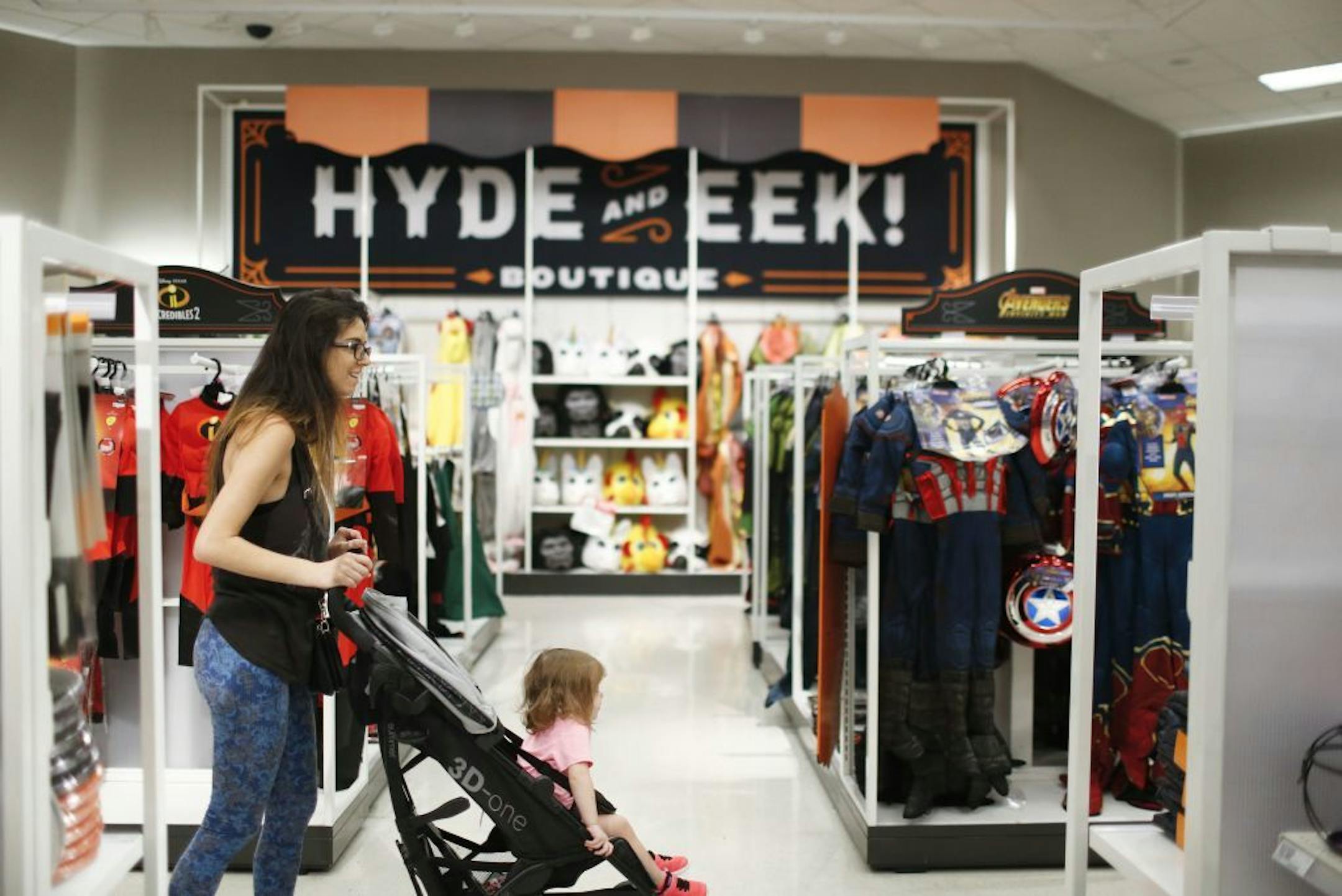 Customers look through the Halloween section called "Hyde and Eek" at a Target department store on Wednesday, Oct. 3, 2018, in Pembroke Pines, Fla. Discounters like Walmart and Target are expanding their costume offerings and creating designated sections where customers can find more of their Halloween needs in one place.