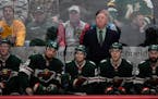 Minnesota Wild players were dejected as head coach Bruce Boudreau watched the replay of the game-winning shot by Columbus Blue Jackets center Alexande