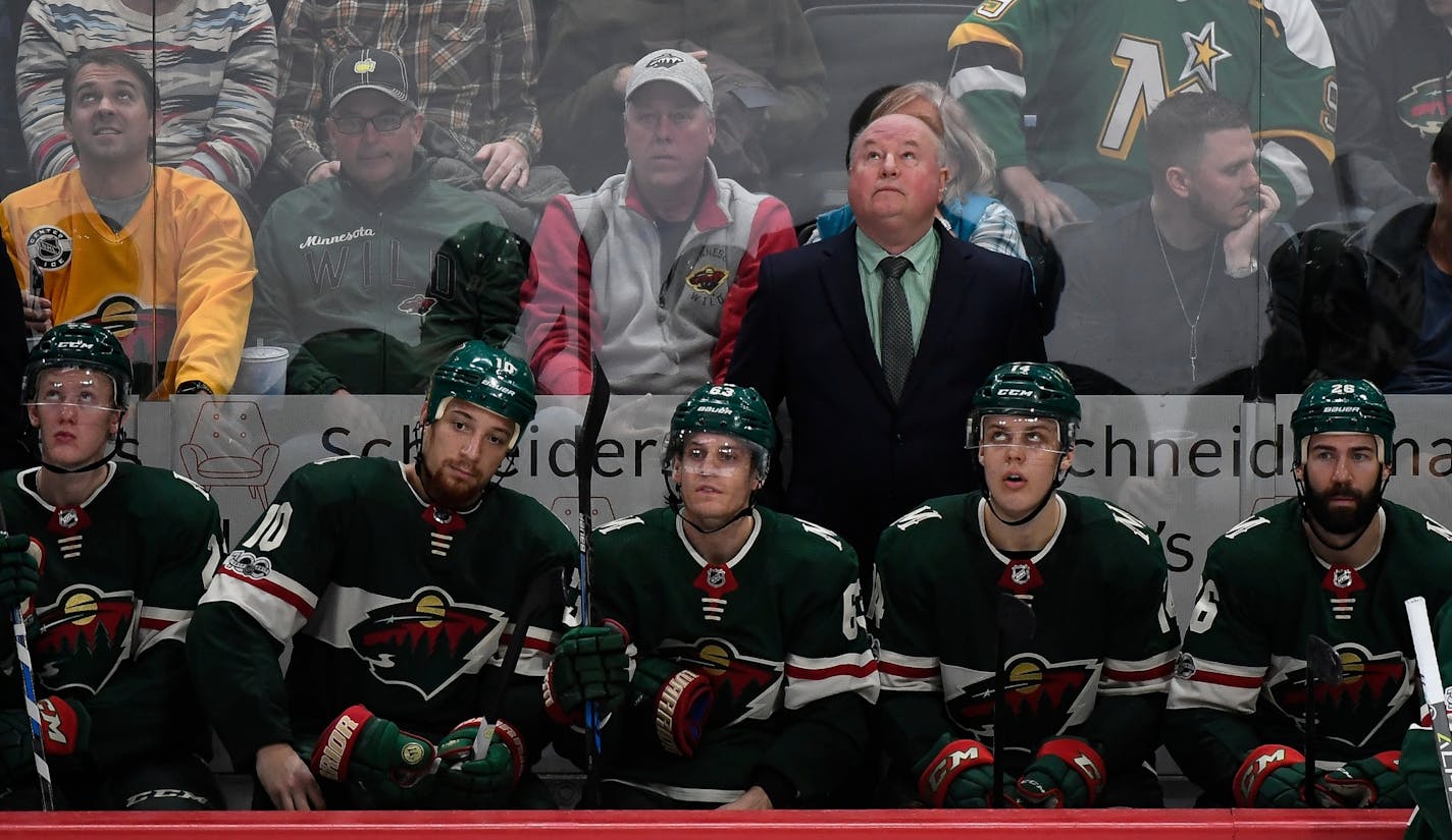 Minnesota Wild players were dejected as head coach Bruce Boudreau watched the replay of the game-winning shot by Columbus Blue Jackets center Alexander Wennberg (10) in overtime.