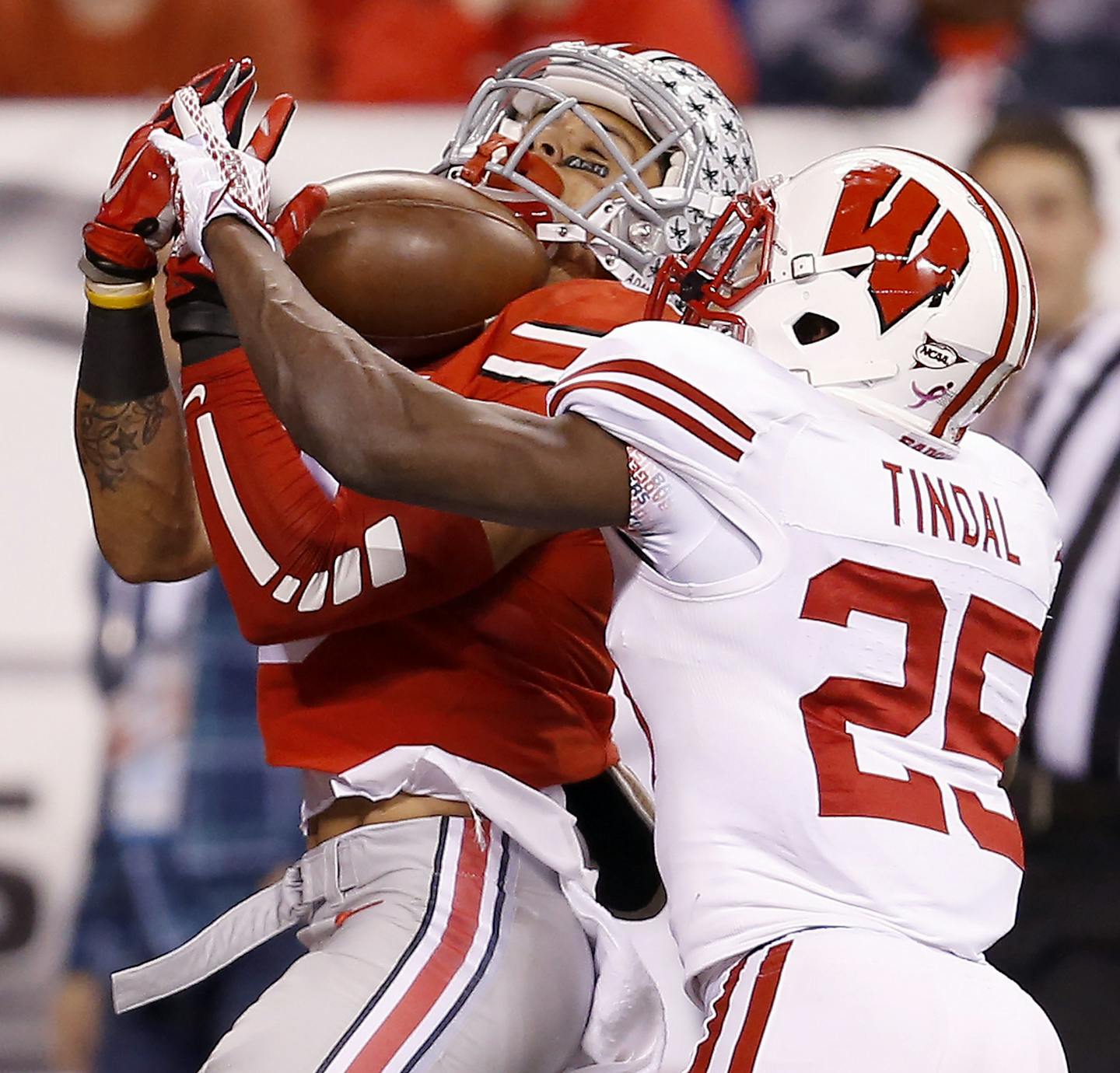 Ohio State wide receiver Devin Smith hauls in a touchdown catch against Wisconsin cornerback Derrick Tindal (25) during first-half action in the 2014 Big Ten championship game at Lucas Oil Stadium in Indianapolis on Saturday, Dec. 6, 2014. (Sam Riche/TNS)