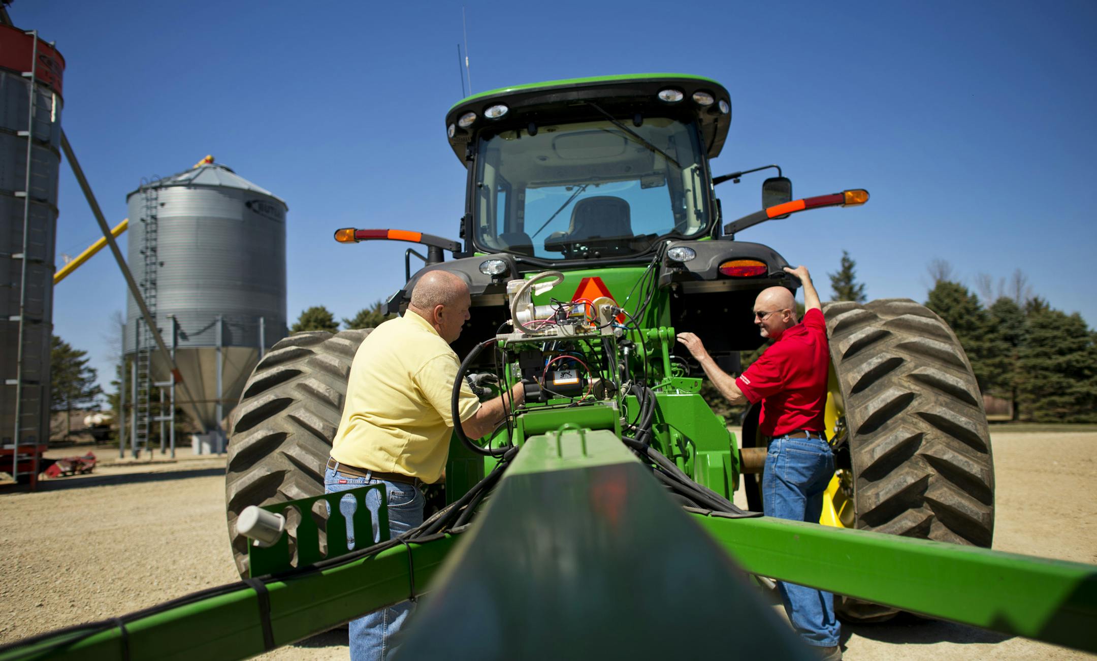 If the weather holds Jerry Demmer, right, expects to start planting his corn and soybean fields this Monday. He was helping his brother Brian get a tractor and planter ready to go. Friday, April 26, 2013 ] GLEN STUBBE * gstubbe@startribune.com EDS, Jerry is wearing red, his brother yellow ORG XMIT: MIN1304261637551092