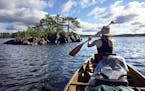 Val paddles past an island on the first day of canoeing –before the Thunderstorms struck.