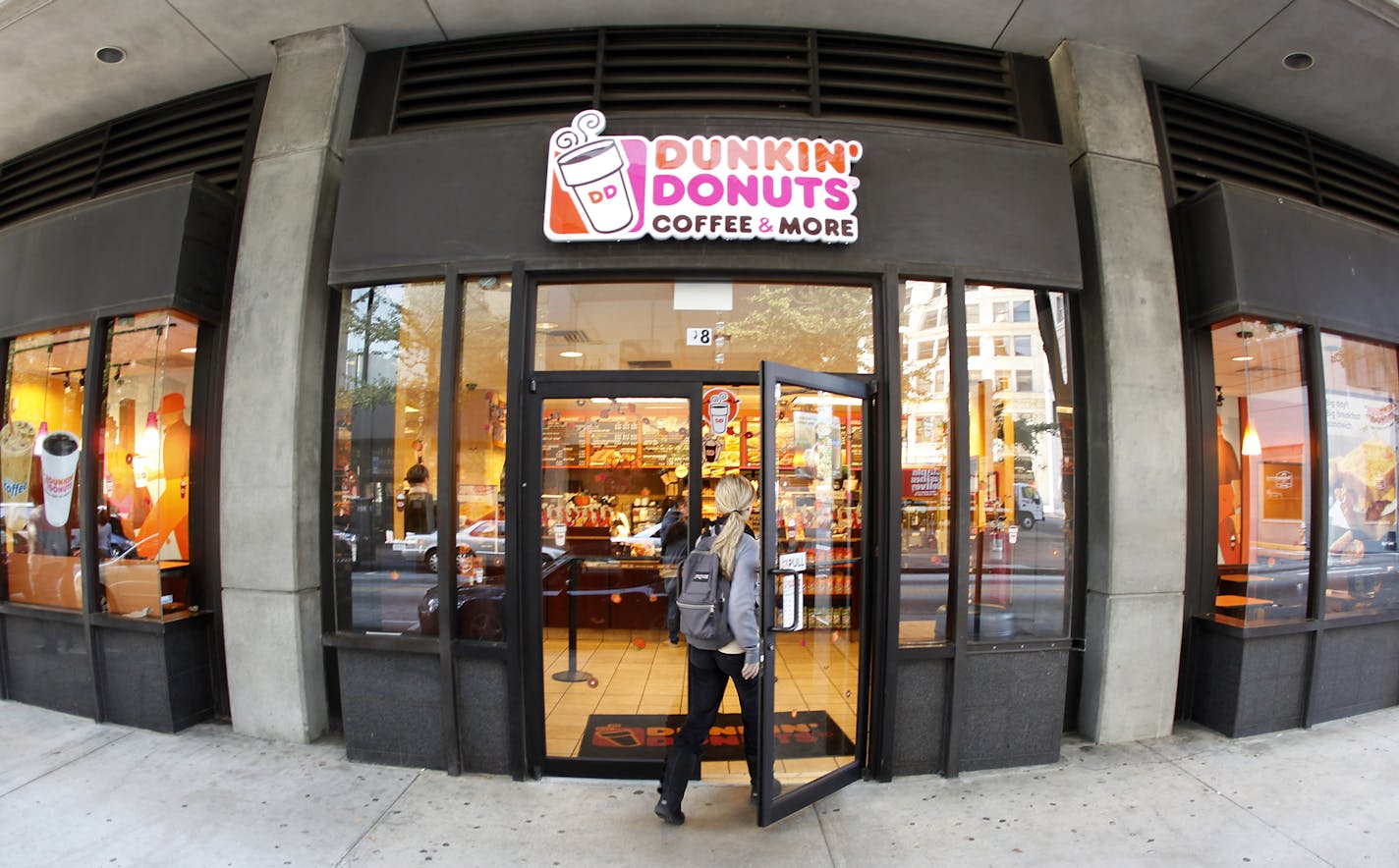 A customer enters a Dunkin' Donuts store Monday, Oct. 31, 2011, in Atlanta. Dunkin' Brands Group Inc., the parent of Dunkin' Donuts and the Baskin-Robbins ice cream chain, said Tuesday, Nov. 1, 2011, that its net income plummeted 61 percent in the July-to-September quarter, as the company paid charges related to going public and paying down debt. (AP Photo/John Bazemore) ORG XMIT: GAJB203