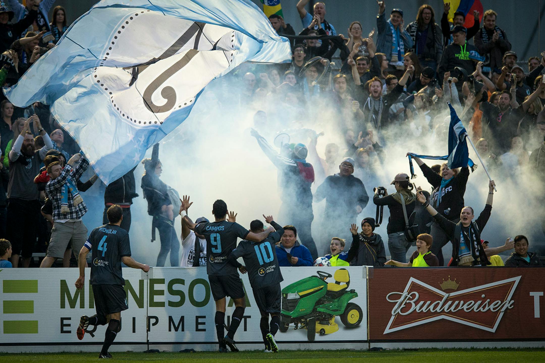 Minnesota United FC's Aaron Pitchkolan (4), Pablo Campos (9) and Miguel Ibarra (10) celebrated a goal by Ibarra with fans during the second half against Jacksonville Armada FC Saturday night. ] Aaron Lavinsky • aaron.lavinsky@startribune.com Minnesota United FC played Jacksonville on Saturday, May 23, 2015 at the National Sports Center in Blaine.