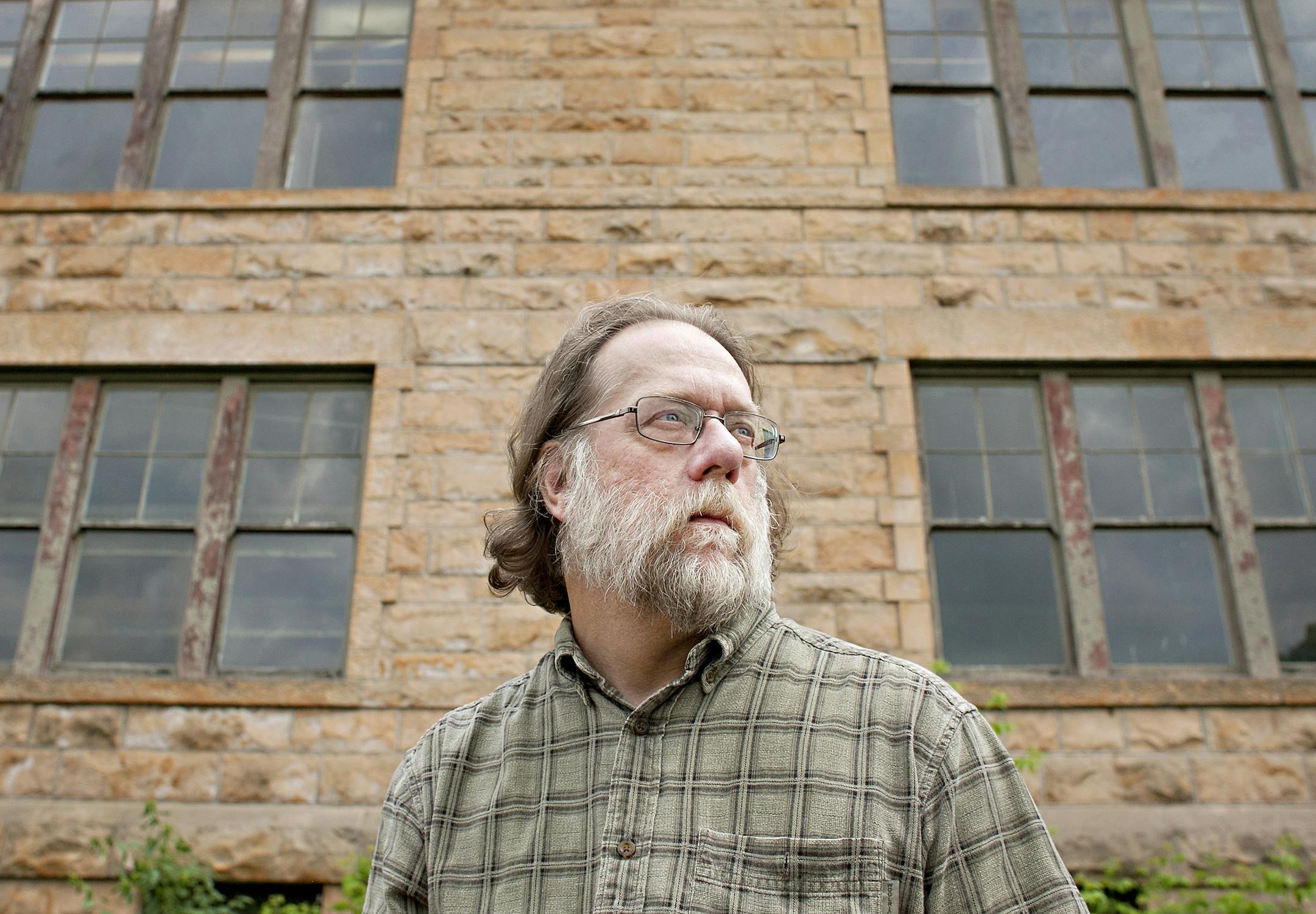 Like many residents of Sandstone, Sam Griffith graduated from the old Sandstone School. “This is a story of a building we can't give away,” says Griffith, who is currently employed by the town of Sandstone, which owns the building, as the city administrator and clerk. (Ann Arbor Miller for MPR)