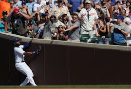 Cubs right fielder Jason Heyward and fans watch as a foul ball bounces off the wall along the first base line in the second inning Friday.