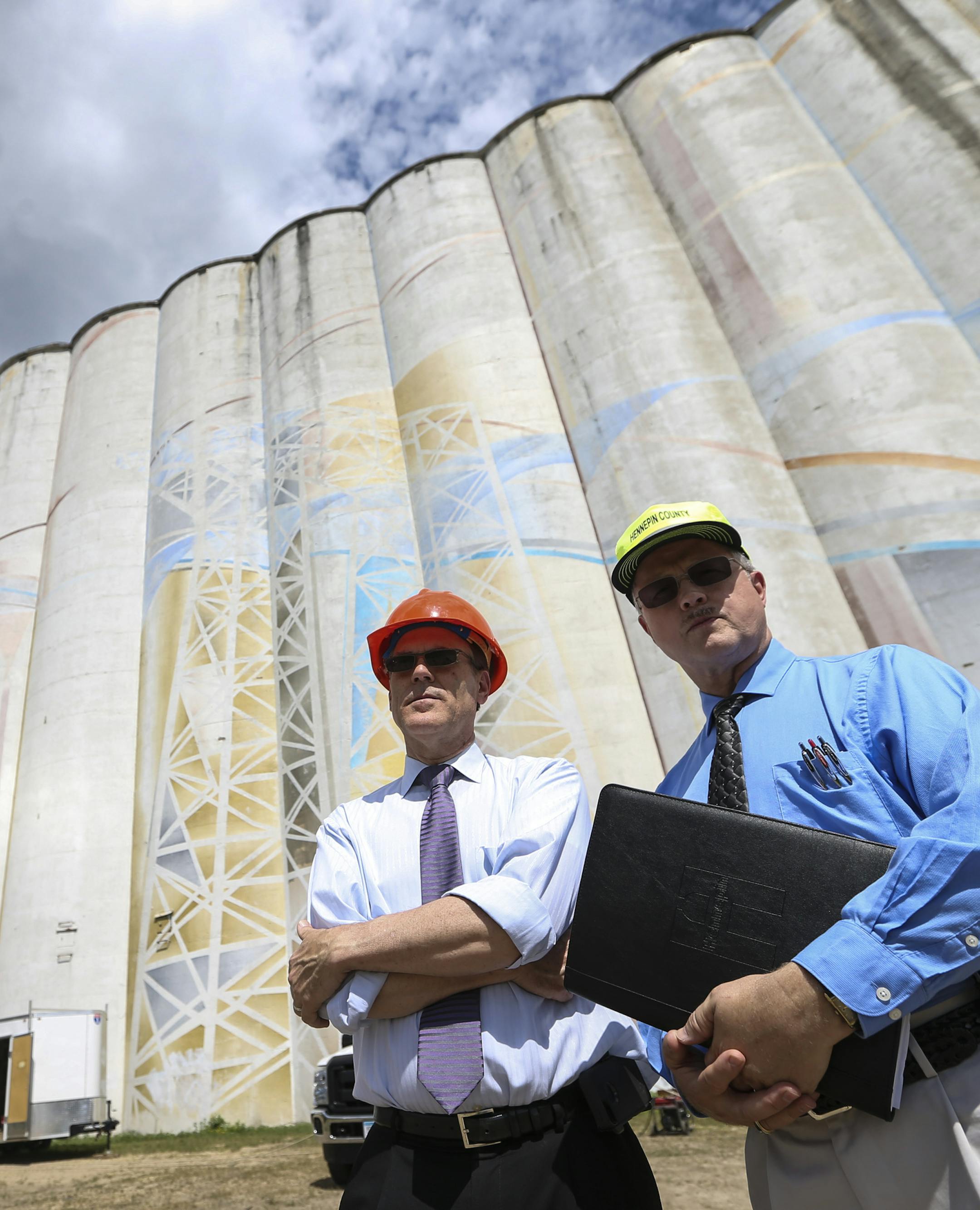 Mark Chapin, Hennepin County's director of taxpayer services, county auditor and county treasurer, and administrative manager Jeff Strand posed for a picture next to the giant abandoned grain elevators on Hiawatha that the city just got back in tax forfeiture on Wednesday, July 23, 2014, in Minneapolis, Minn. ] RENEE JONES SCHNEIDER • reneejones@startribune.com