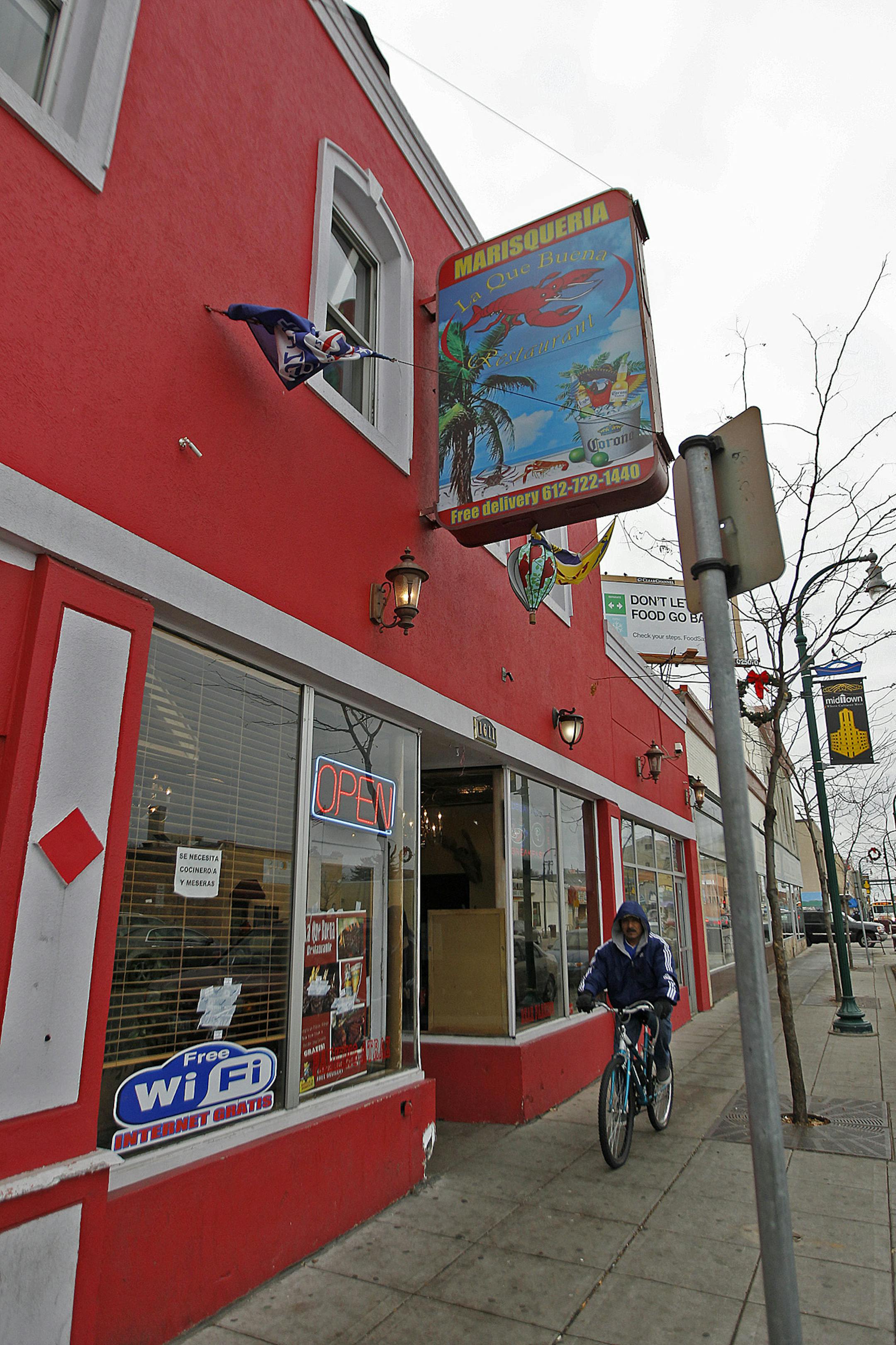 Bullet holes were covered with tape outside La Que Buena Seafood Restaurant where police were called to the restaurant in south Minneapolis around 1:30 a.m., Monday, November 25, 2013.