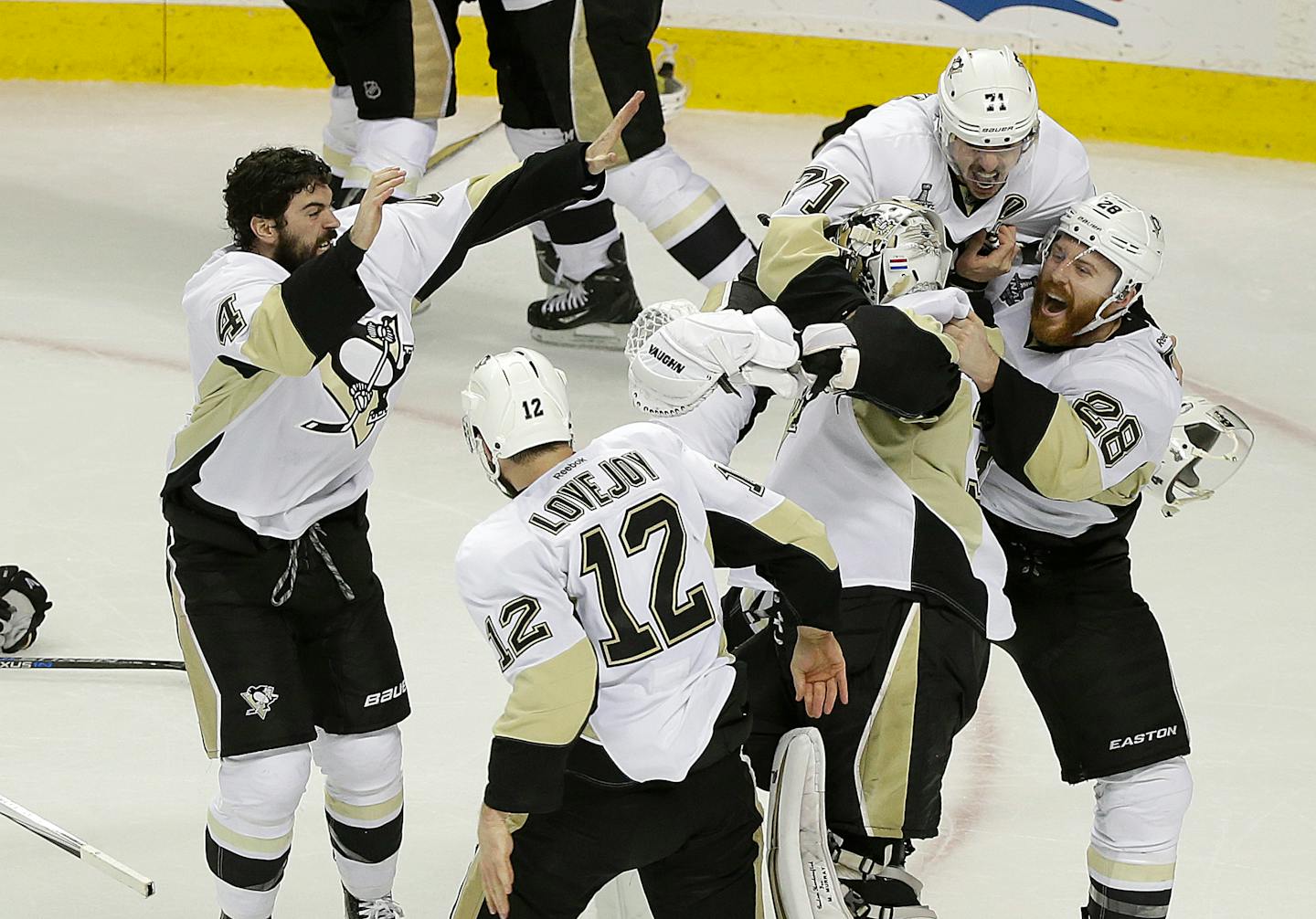 Pittsburgh Penguins players celebrate around goalie Matt Murray, center, after beating the San Jose Sharks in Game 6 of the NHL hockey Stanley Cup Finals in San Jose, Calif., Sunday, June 12, 2016. The Penguins won 3-1 to win the series 4-2. (AP Photo/Eric Risberg)