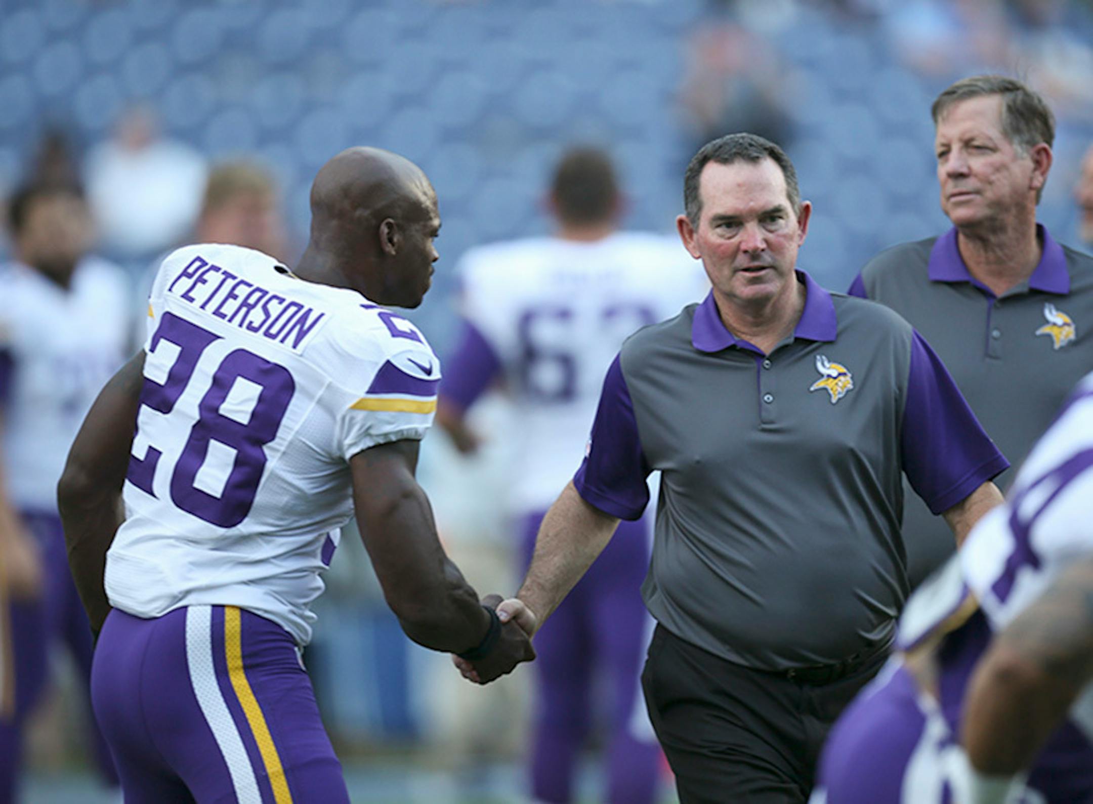 Vikings head coach Mike Zimmer shook hands with all the players, including Adrian Peterson, as they stretched before a preseason game this summer. Zimmer, in his second season, and second-year QB Teddy Bridgewater finally get a full season with Peterson beginning Monday night.
