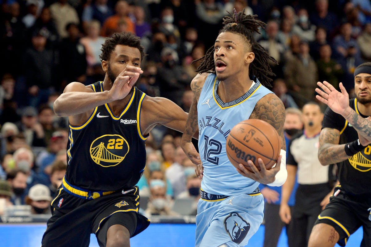 Grizzlies guard Ja Morant (12) raced past Golden State’s Andrew Wiggins on Tuesday as Memphis won its tenth consecutive game.