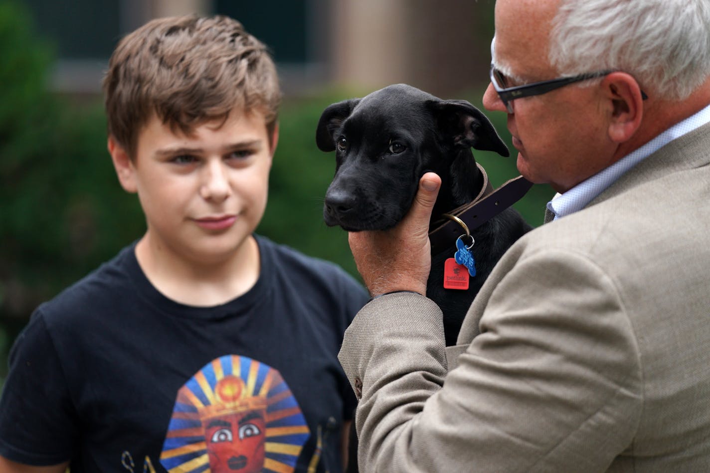 Gov. Tim Walz held Scout, a 3-month-old Labrador Retriever the Walz family adopted, during a press conference to announce the family's newest addition at the residence Thursday afternoon.