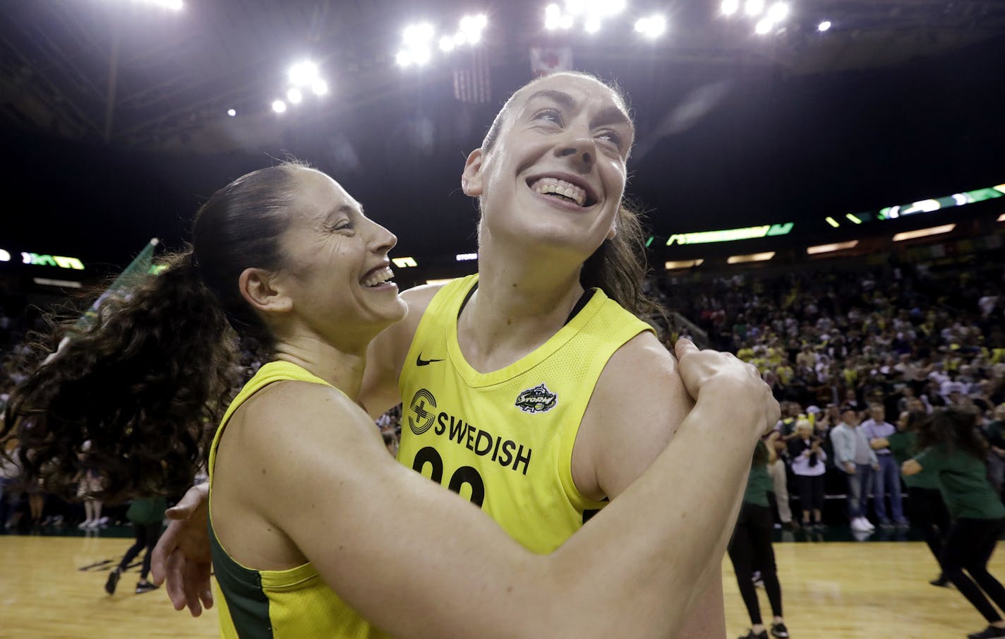 FILE - This Sept. 4, 2018, file photo shows Seattle Storm's Sue Bird, left, and Breanna Stewart embracing after the Storm defeated the Phoenix Mercury 94-84 during Game 5 of a WNBA basketball playoff semifinal, in Seattle. With Breanna Stewart and Sue Bird back, the Seattle Storm are healthy to begin the season and sit atop the preseason Associated Press WNBA poll. The Storm were the unanimous choice receiving all 16 first-place votes from the national media panel Tuesday, July 21, 2020. (AP Pho