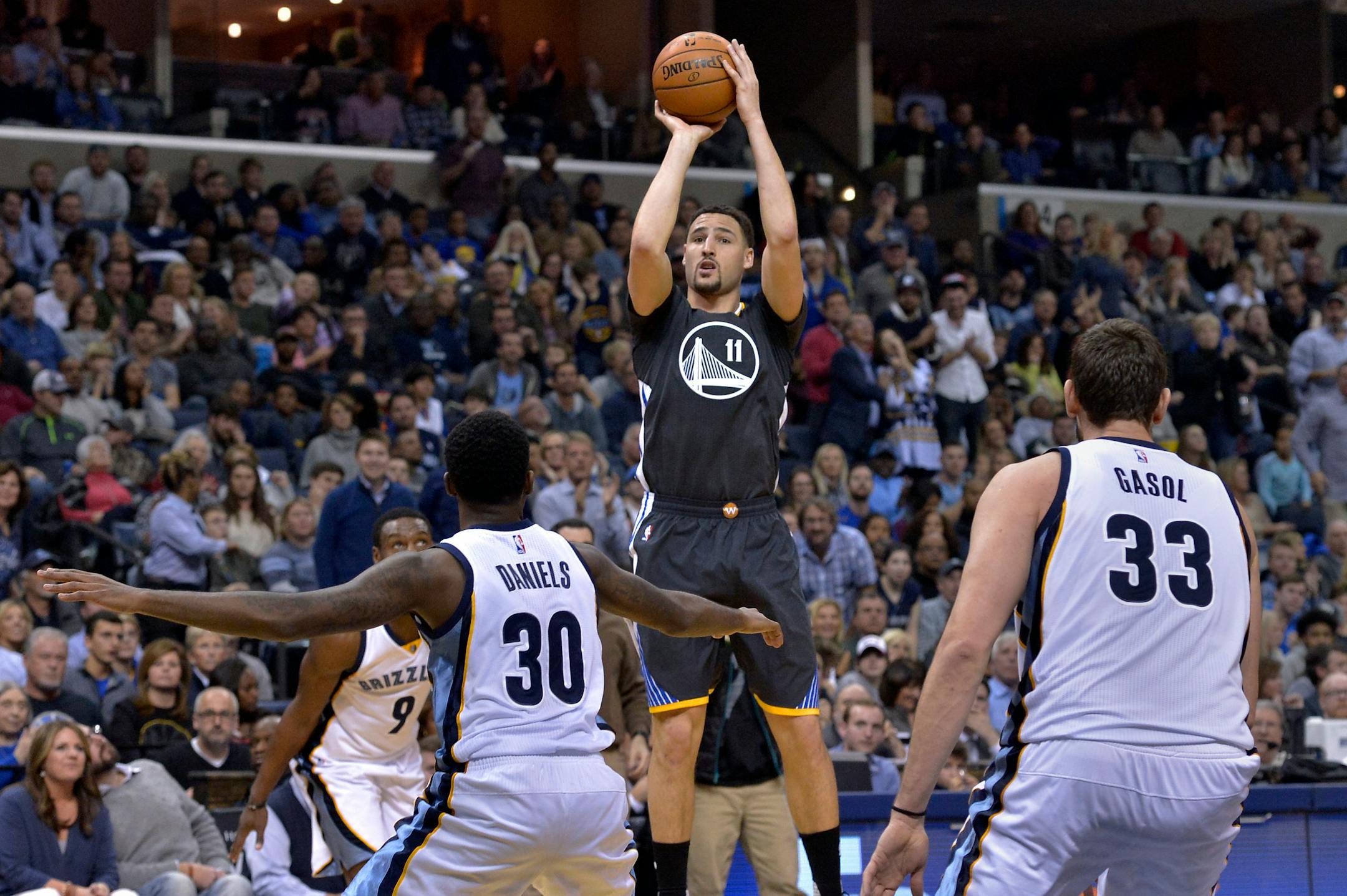 Golden State Warriors guard Klay Thompson (11) shoots between Memphis Grizzlies guards Tony Allen (9) and Troy Daniels (30) and center Marc Gasol (33) in the first half of an NBA basketball game Saturday, Dec. 10, 2016, in Memphis, Tenn. (AP Photo/Brandon Dill)
