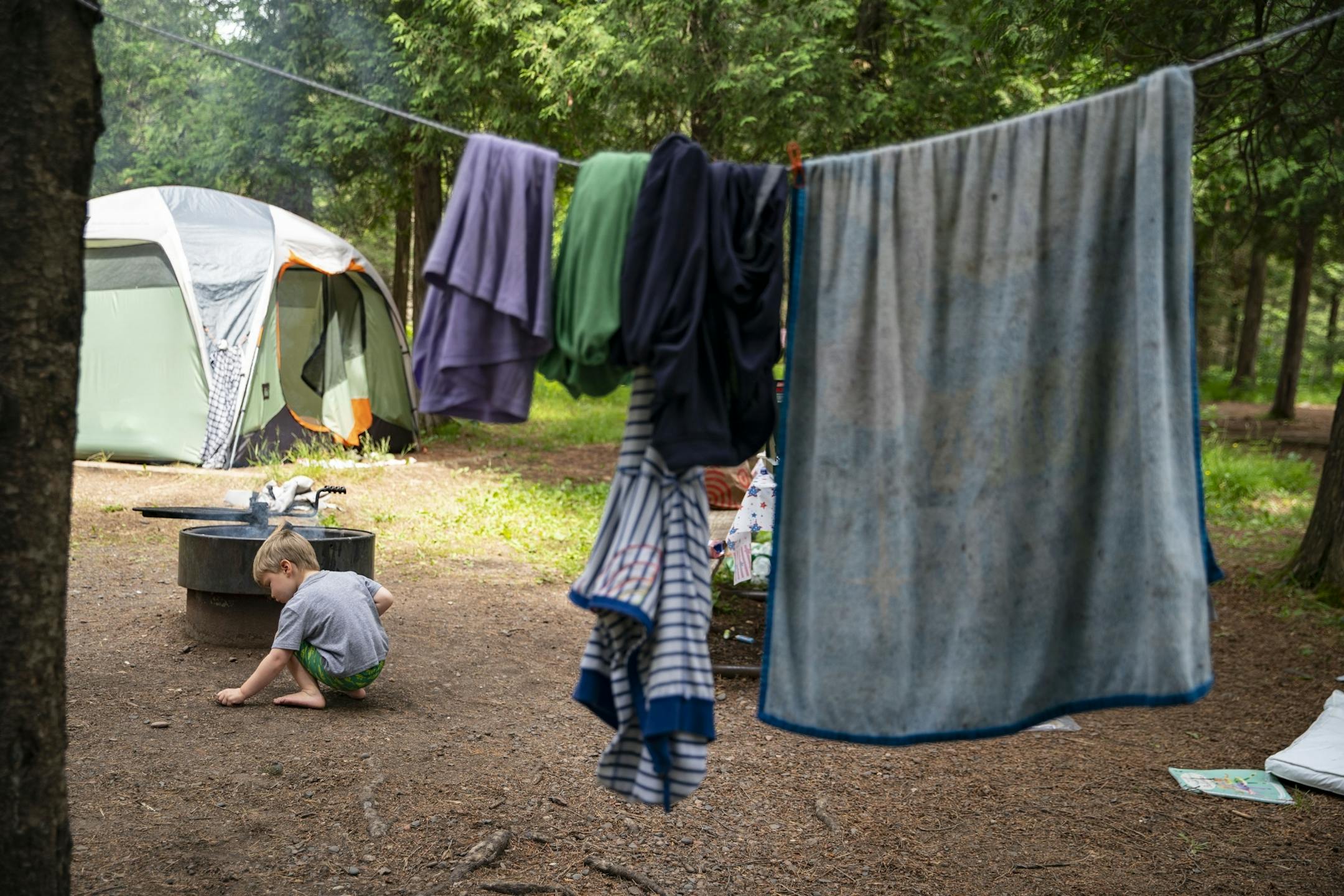Tommy McLafferty (5) played near the fire his father had made at their campsite in Jay Cooke State Park on Wednesday.