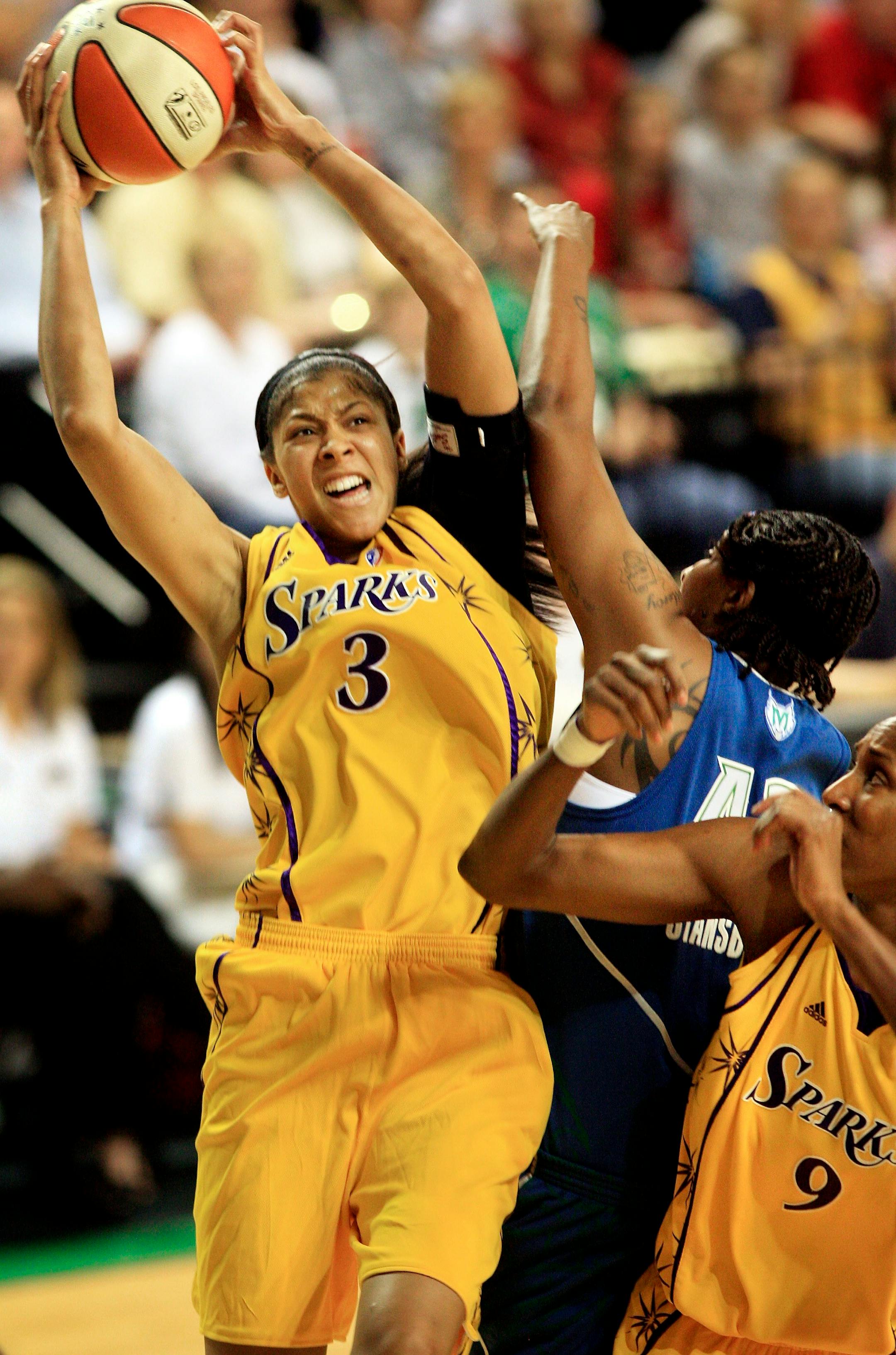 Los Angeles Sparks' Candace Parker, left, drives to the basket as Minnesota Lynx's Tiffany Stansbury, center, defends and Sparks' Lisa Leslie, right, blocks in the second half of their WNBA exhibition game Sunday, May 11, 2008, at the Betty Engelstad Arena in Grand Forks, N.D.