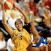 Los Angeles Sparks' Candace Parker, left, drives to the basket as Minnesota Lynx's Tiffany Stansbury, center, defends and Sparks' Lisa Leslie, right, 